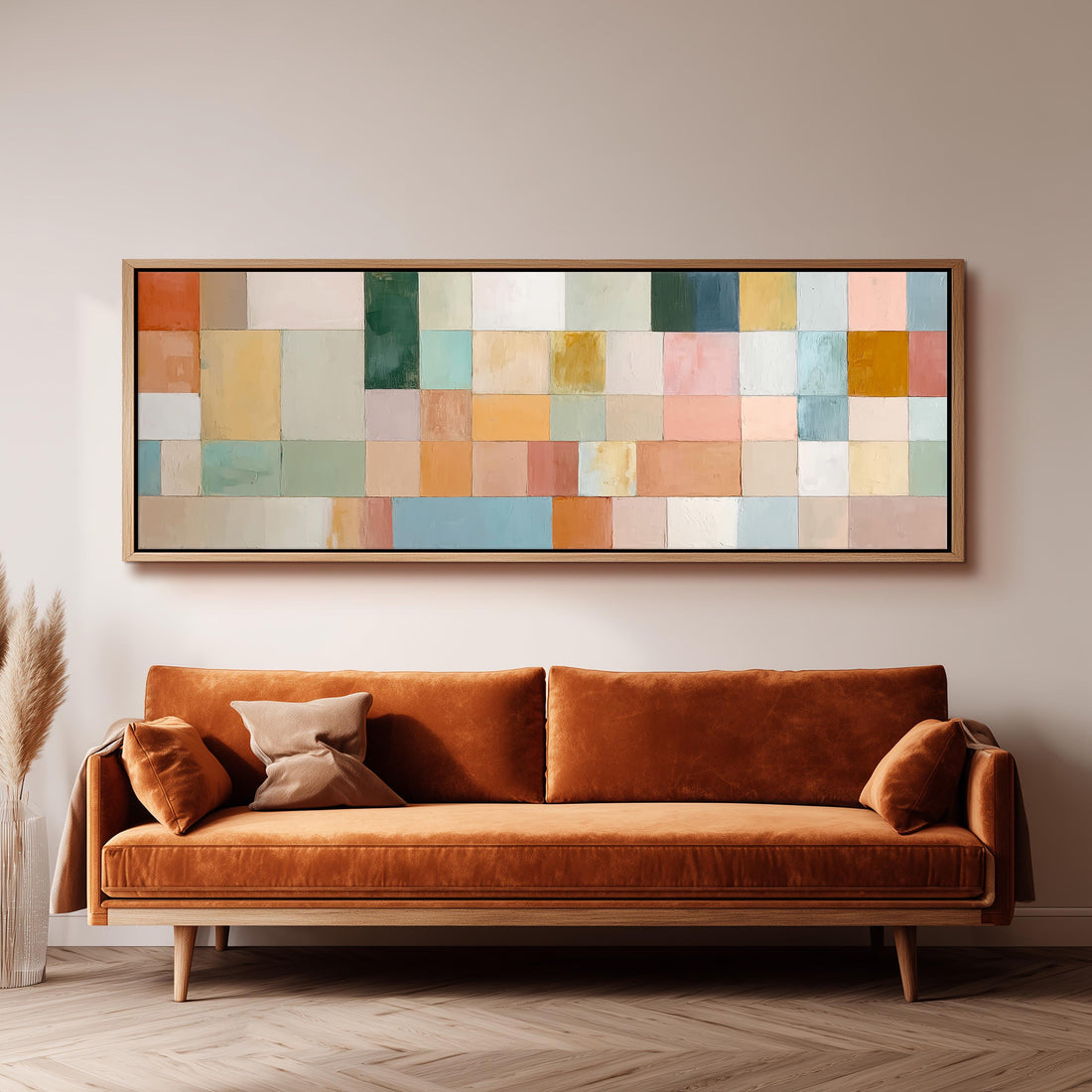 a large, rectangular abstract painting hanging on a wall above a brown sofa with two pillows.