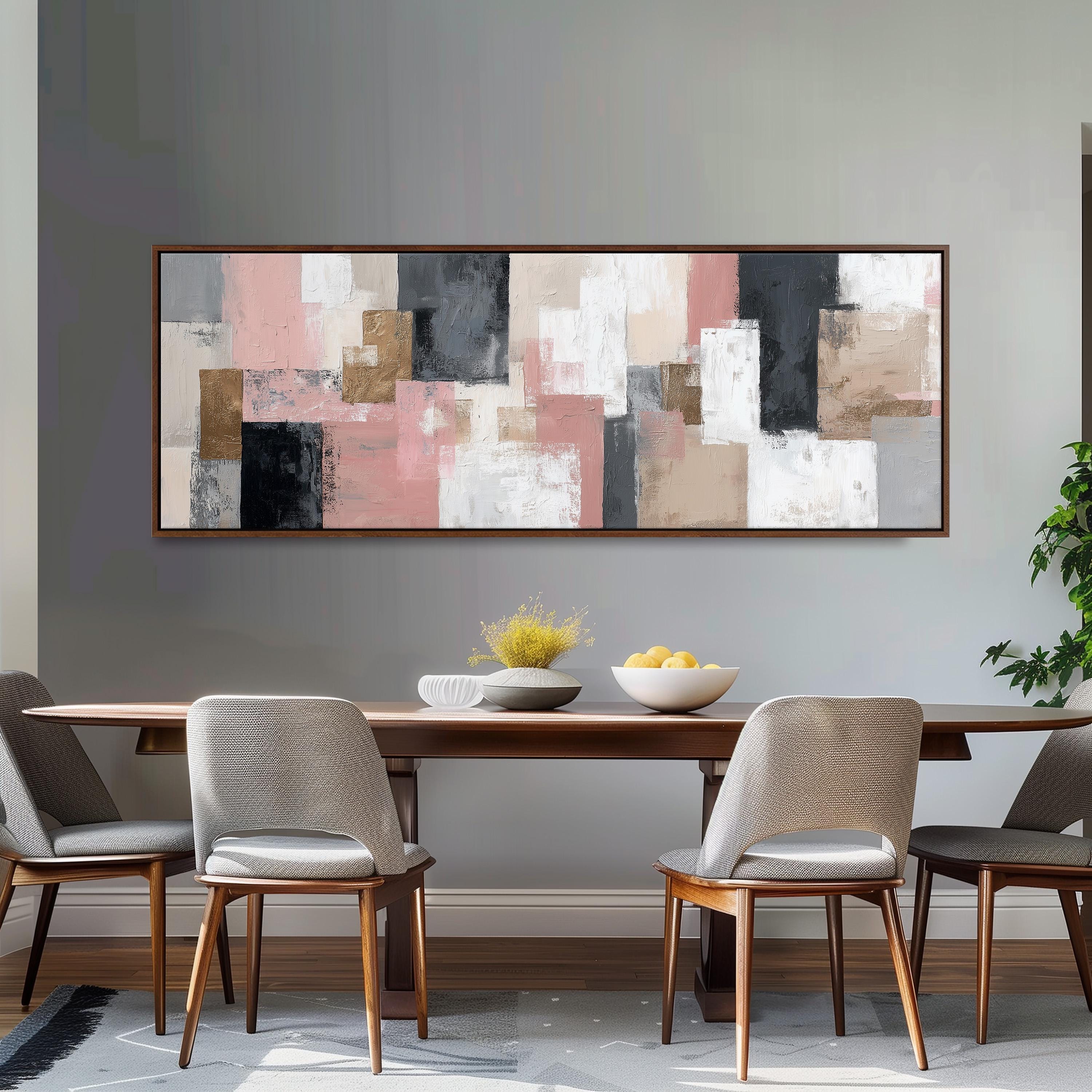 a dining room with a large abstract painting hanging on the wall above a wooden table with four chairs. The table is set with a bowl of fruit and a vase of flowers, creating a cozy and inviting atmosphere.
