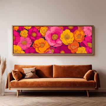 a large, vibrant floral print hanging on a wall above a brown sofa.