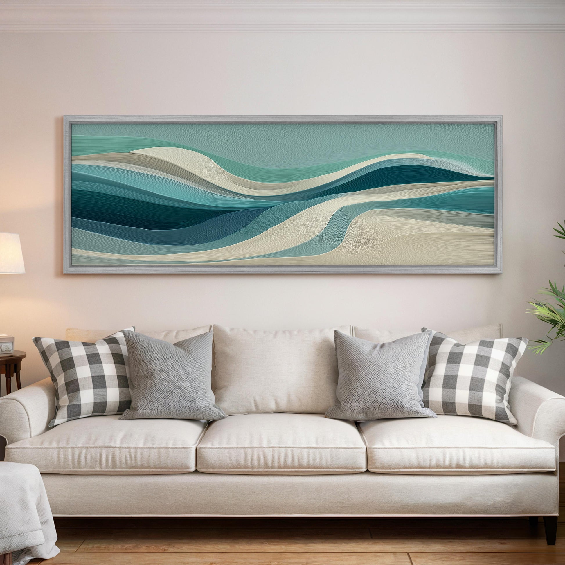 a large, abstract painting hanging on a wall above a white couch with gray and white plaid throw pillows.