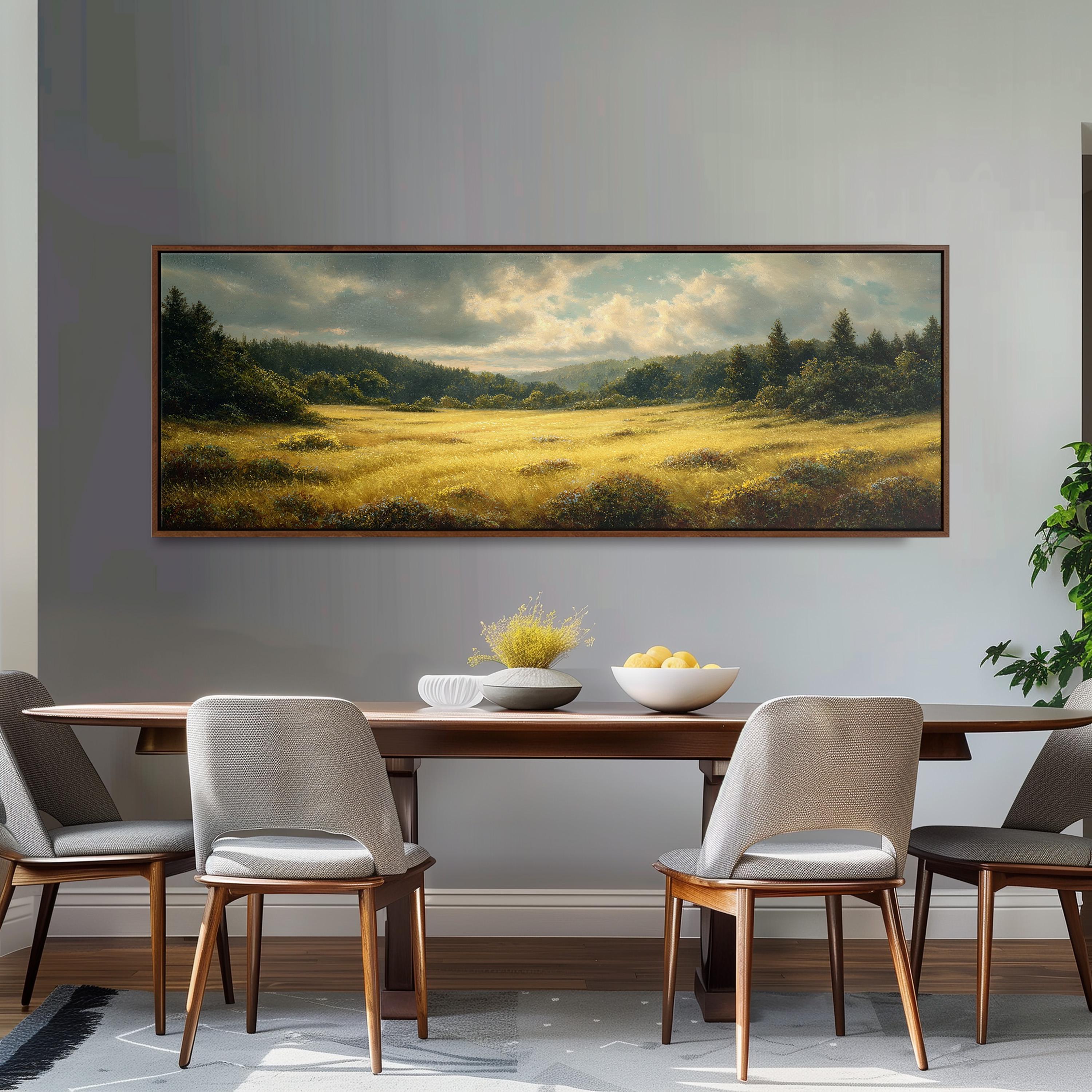 a dining room with a large painting of a field hanging on the wall above a wooden table with four chairs. The table is set with a bowl of fruit and a vase of flowers, creating a cozy and inviting atmosphere.