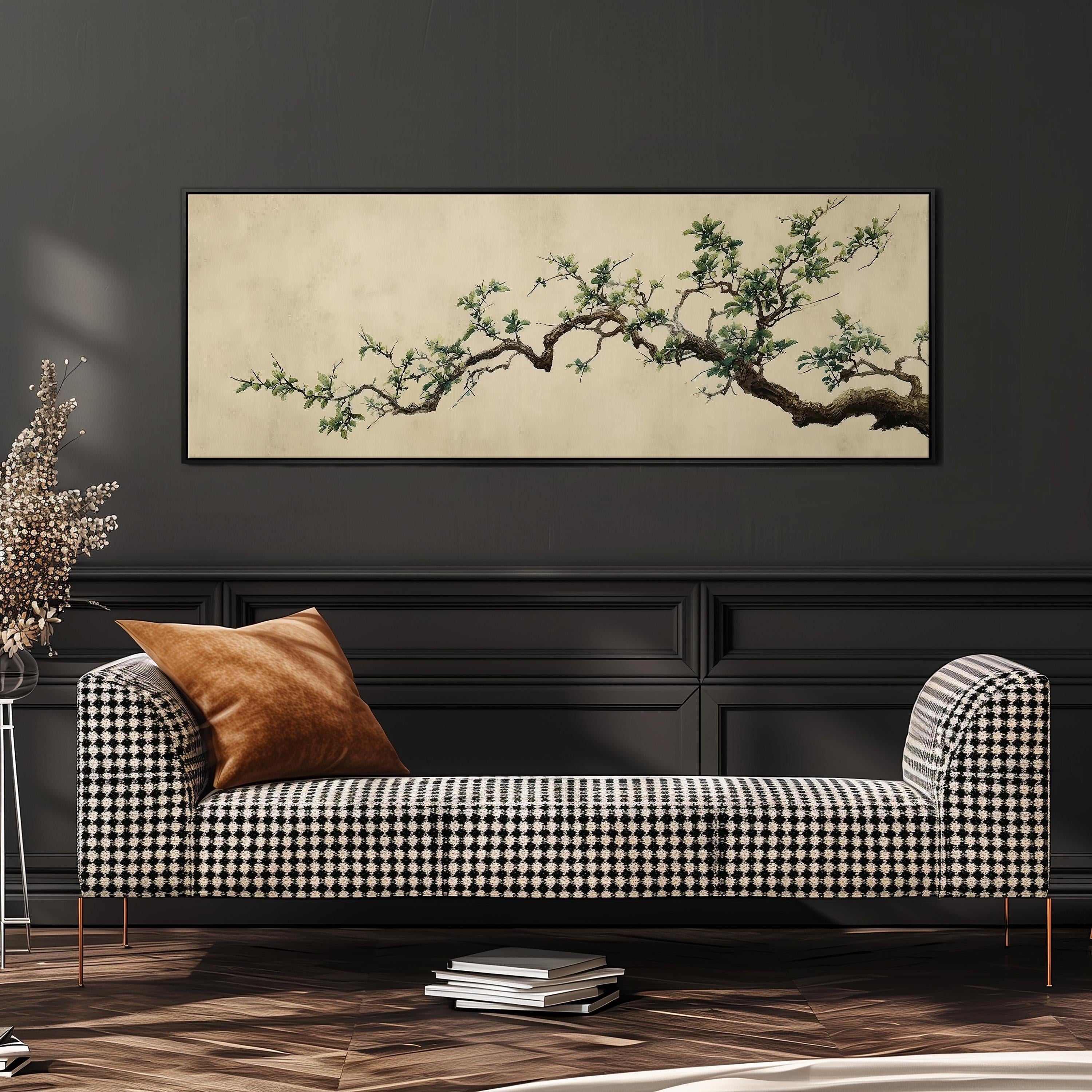 a black and white checkered sofa with a brown throw pillow, set against a dark wall with a large framed painting of a tree branch above it.