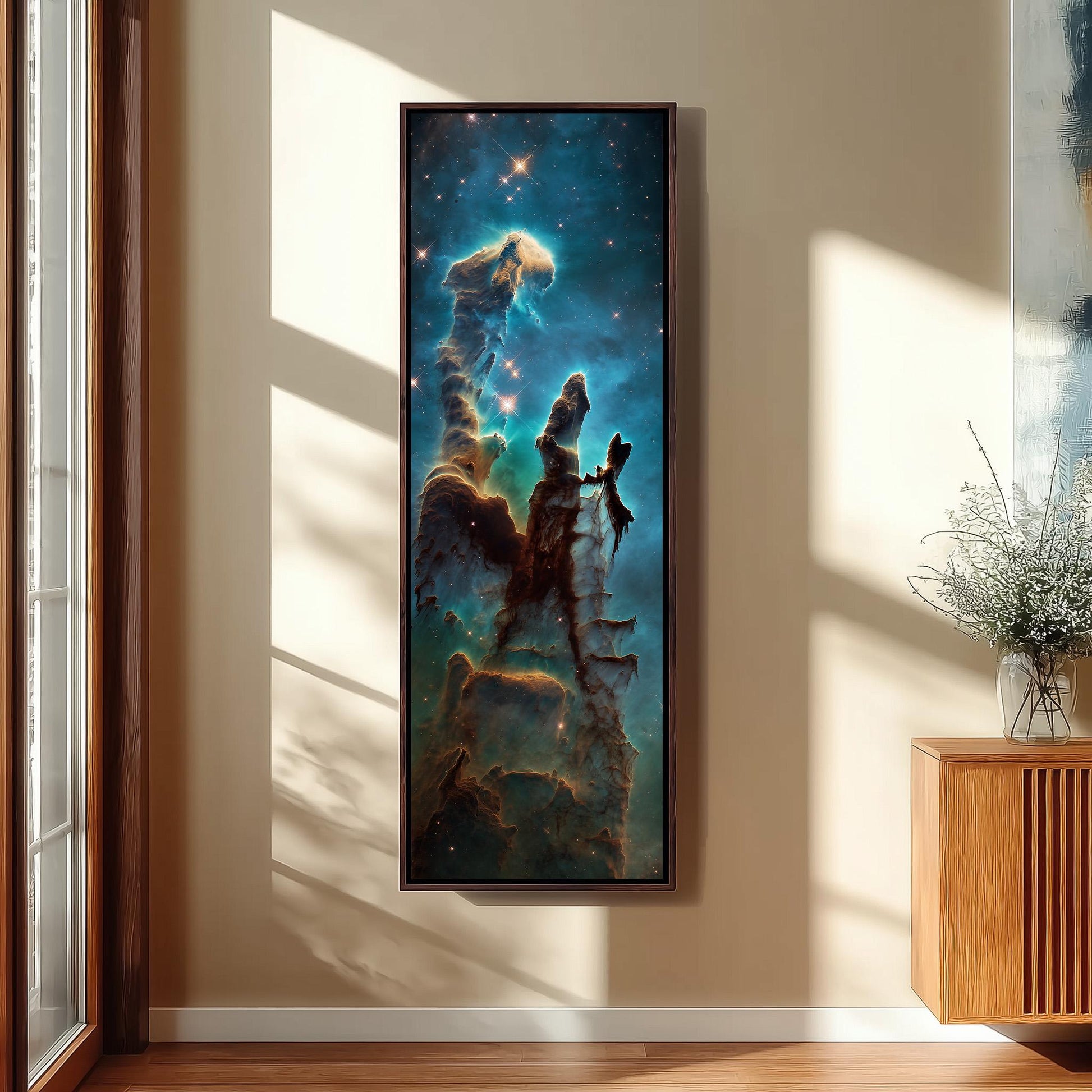 a large framed painting of a nebula hanging on a wall in a room with a wooden cabinet and a vase of flowers.