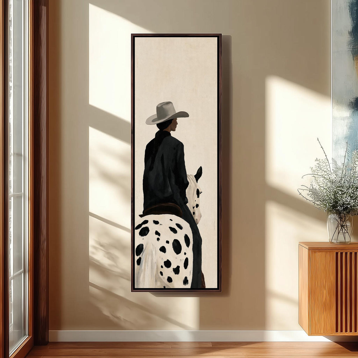 Cowgirl on a spotted appaloosa from behind long vertical canvas print in a sunlit living space