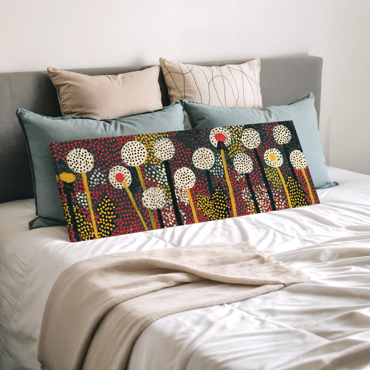 Dotted dandelion meadow wide panoramic canvas print laid on a bed to show its size