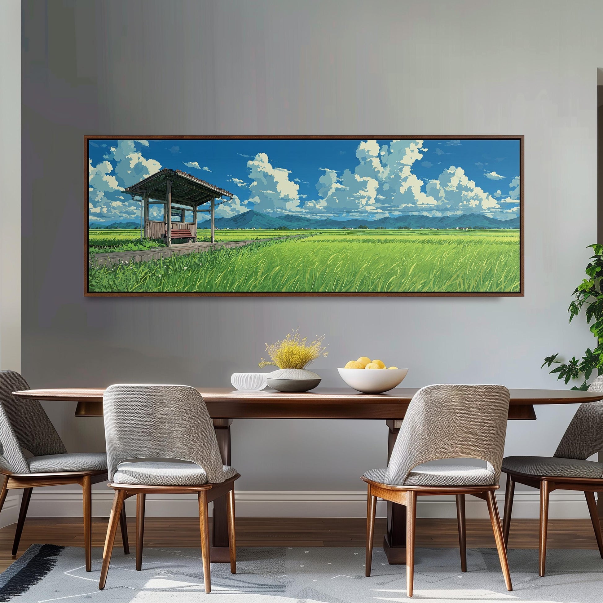 a large painting of a serene landscape with a wooden structure, a field of tall grass, and a blue sky with white clouds. The painting is hung on a wall above a wooden dining table with four chairs.