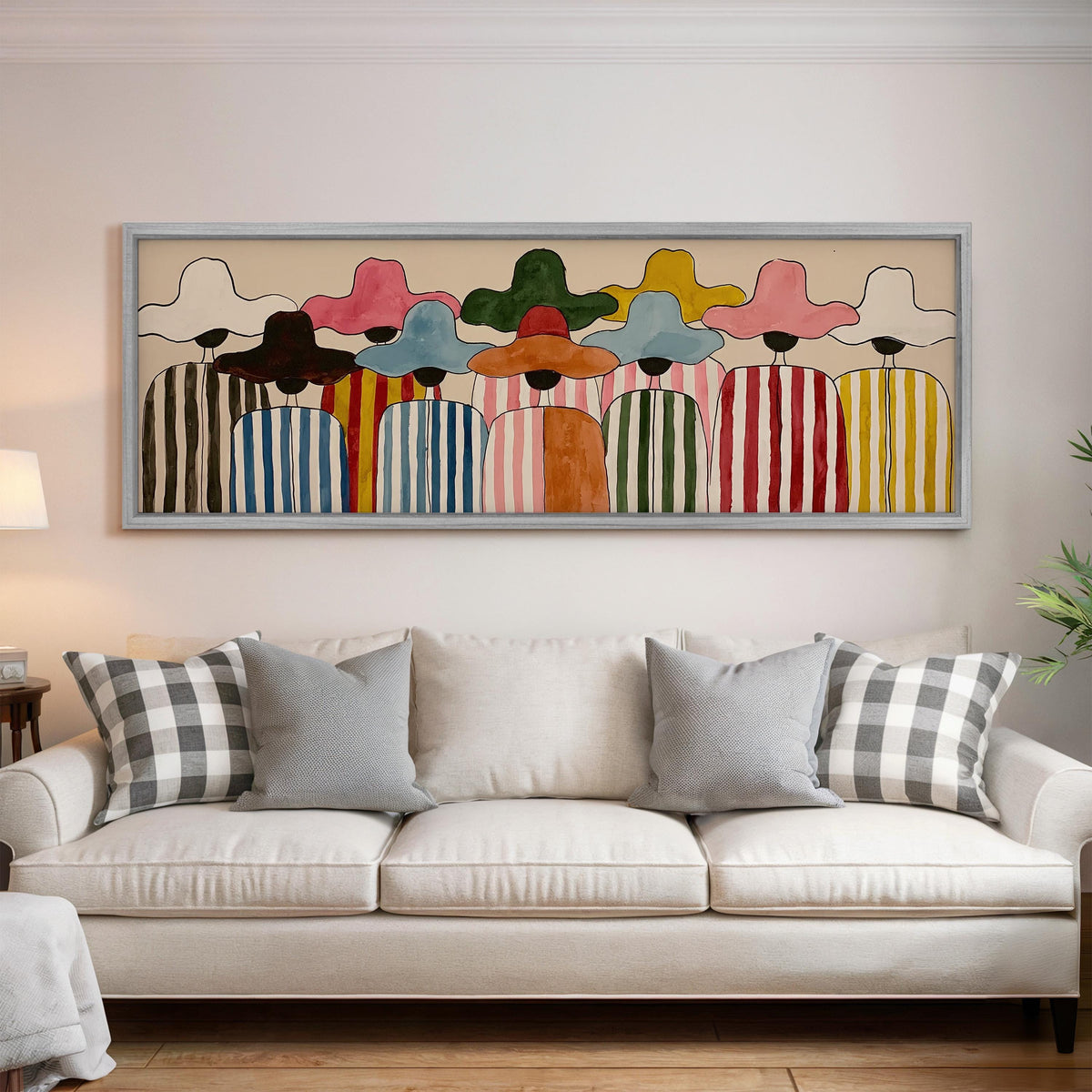 Crowd of figures in colorful sun hats panoramic canvas print above a white sofa in a bright living room