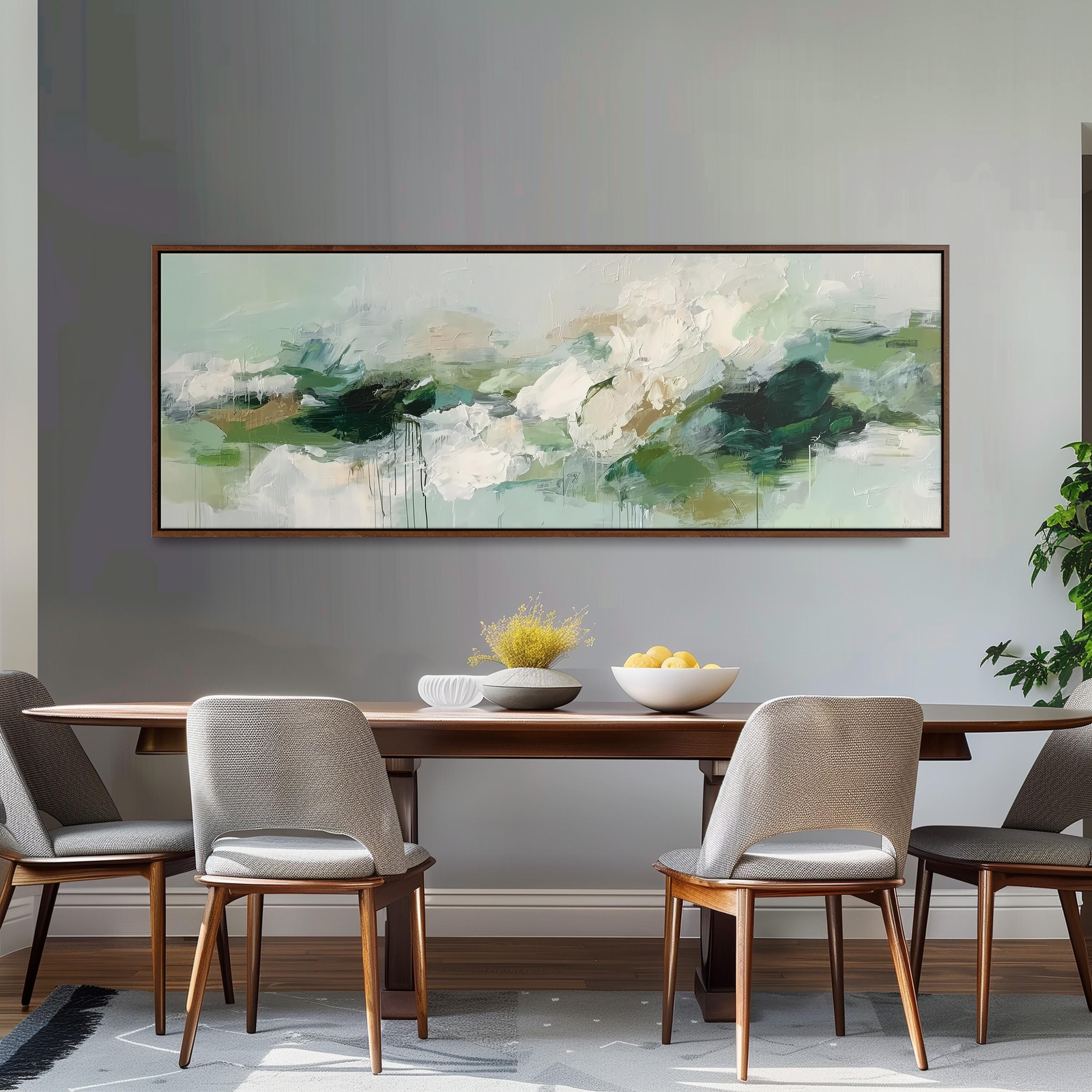 a dining room with a large abstract painting hanging on the wall above a wooden table with four chairs. The table is set with a bowl of fruit and a vase of flowers, creating a cozy and inviting atmosphere.