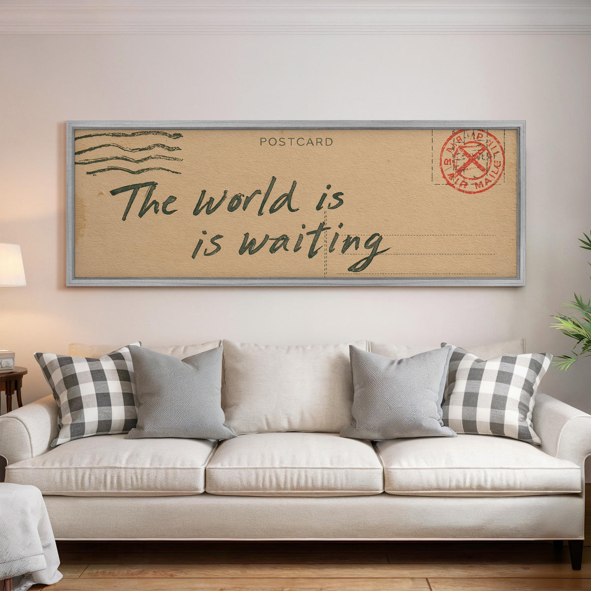 Vintage postcard saying the world is waiting panoramic canvas print above a white sofa in a bright living room