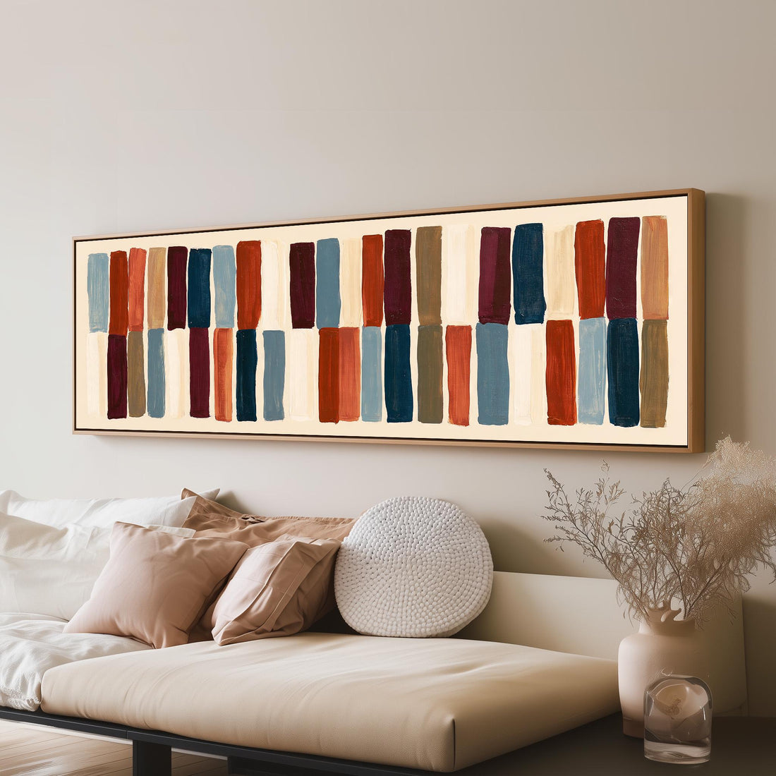Two tiers of staggered stripe blocks long horizontal canvas print above a sofa in a living room