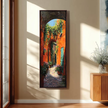 a large, colorful painting of a narrow alleyway with a stone path, surrounded by lush greenery and vibrant orange walls.