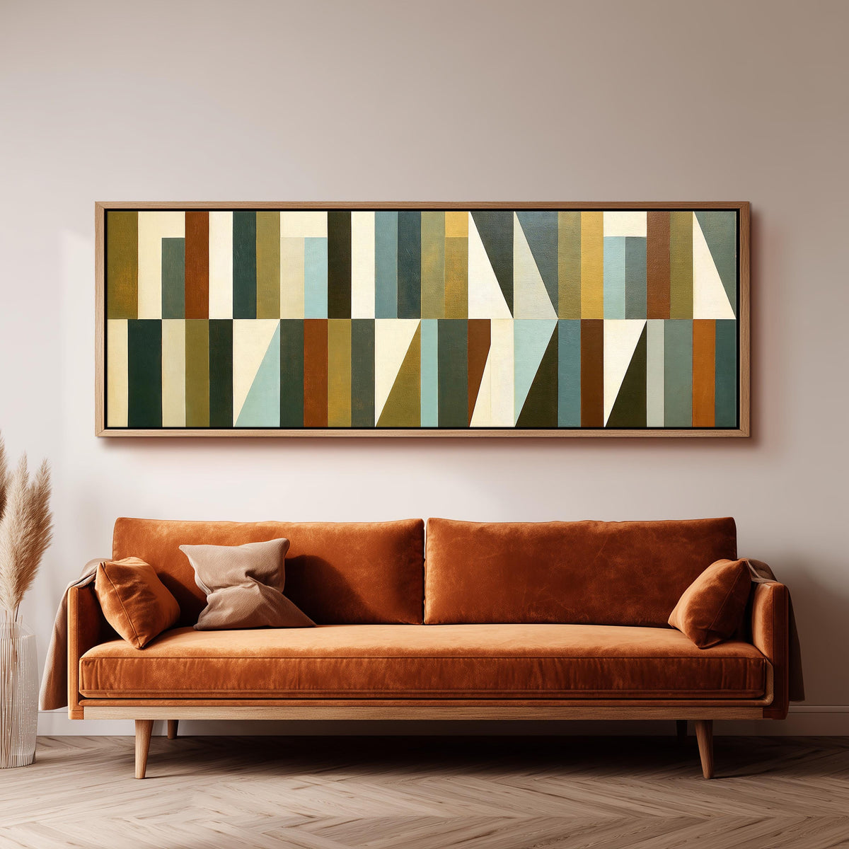 Earth tone geometric triangles long horizontal canvas print above a sofa in a living room
