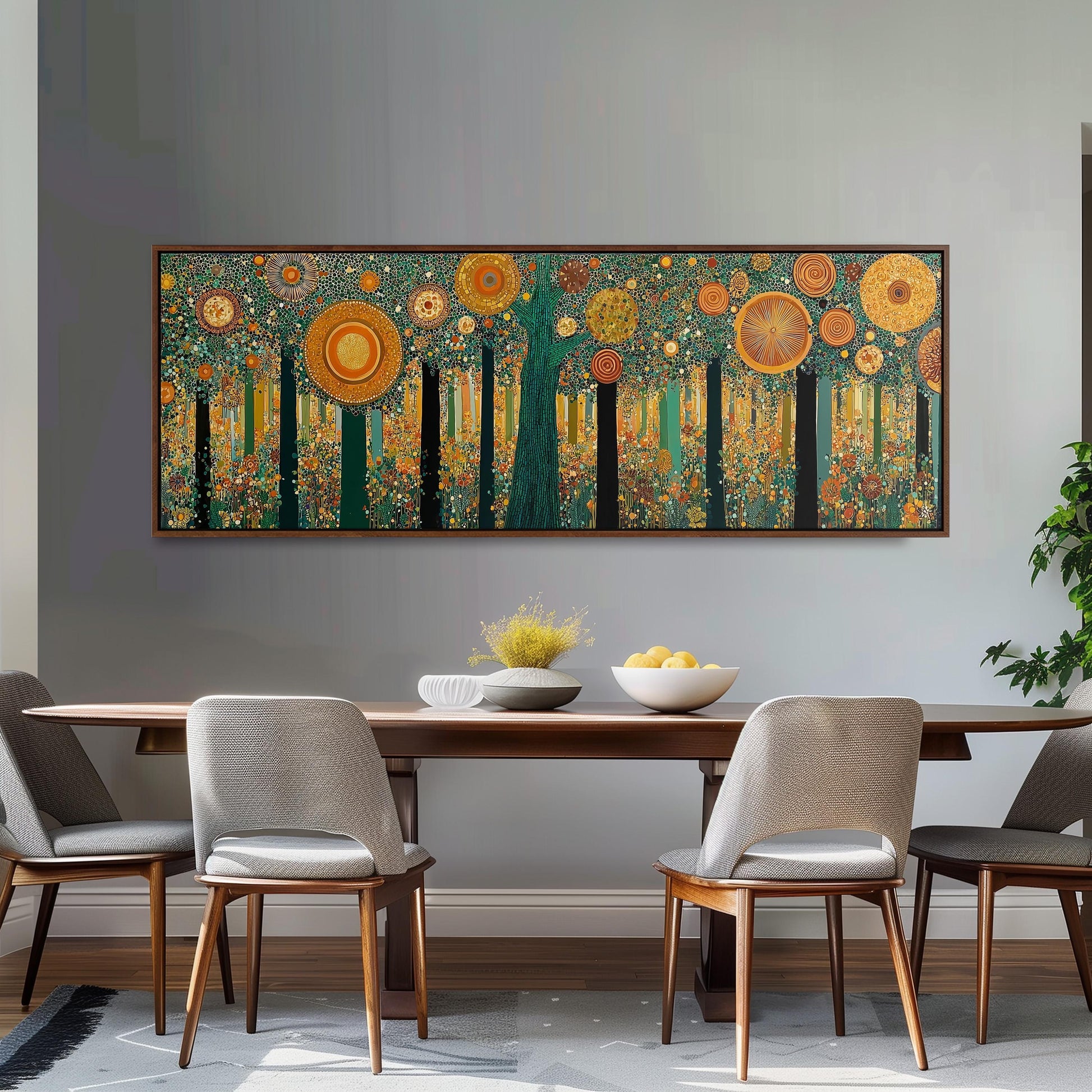 a dining room with a large, colorful painting of a forest hanging on the wall above a wooden dining table with four chairs. The table is set with a bowl of fruit and a vase of flowers, creating a warm and inviting atmosphere.