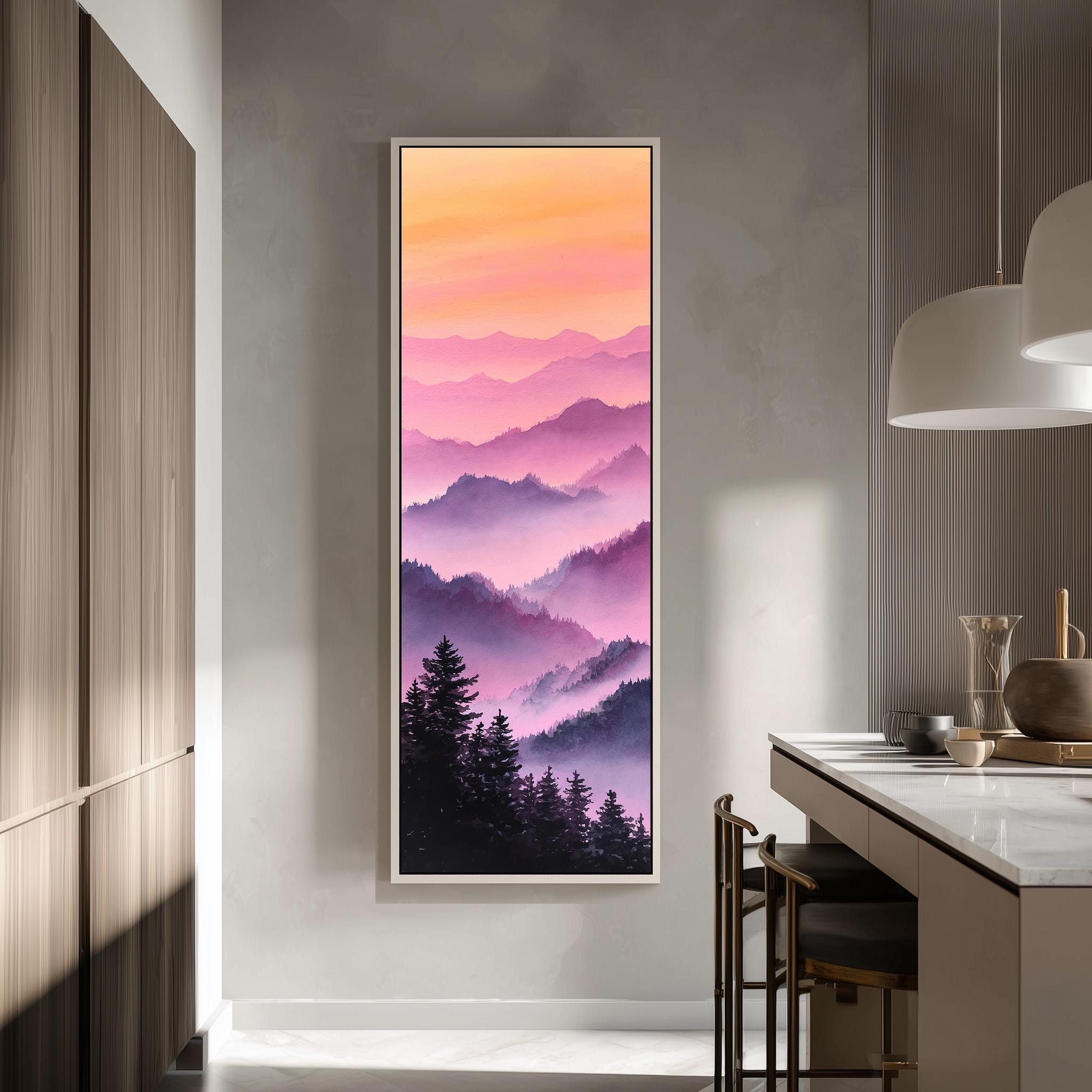 a large framed painting of a mountain landscape with a warm, colorful sky. The painting is hanging on a wall in a modern kitchen with a countertop and chairs.
