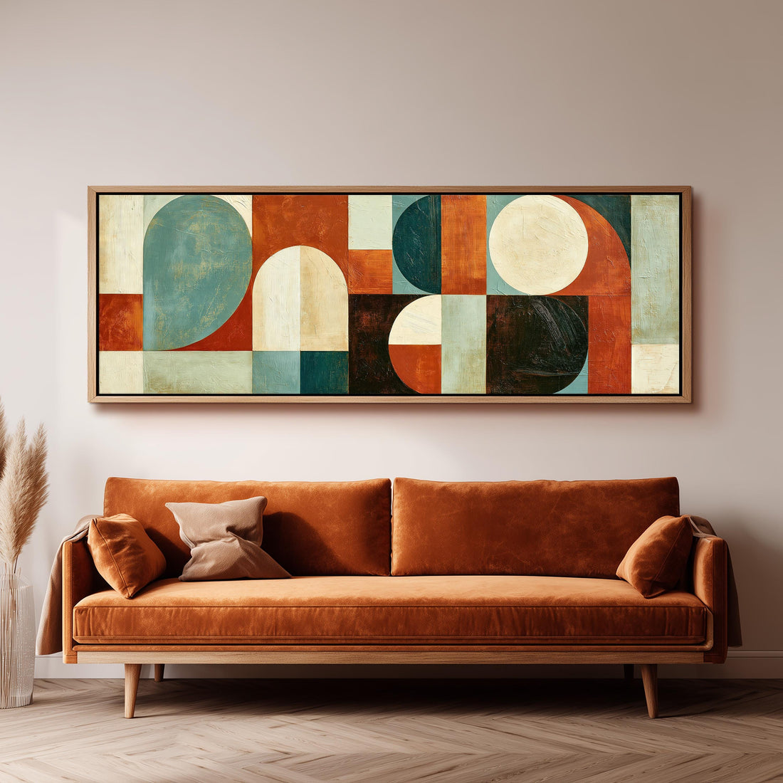 Teal and rust arch and circle shapes long horizontal canvas print above a sofa in a living room