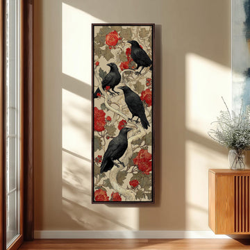 a framed artwork of black birds perched on a branch with red flowers, hanging on a wall in a room.