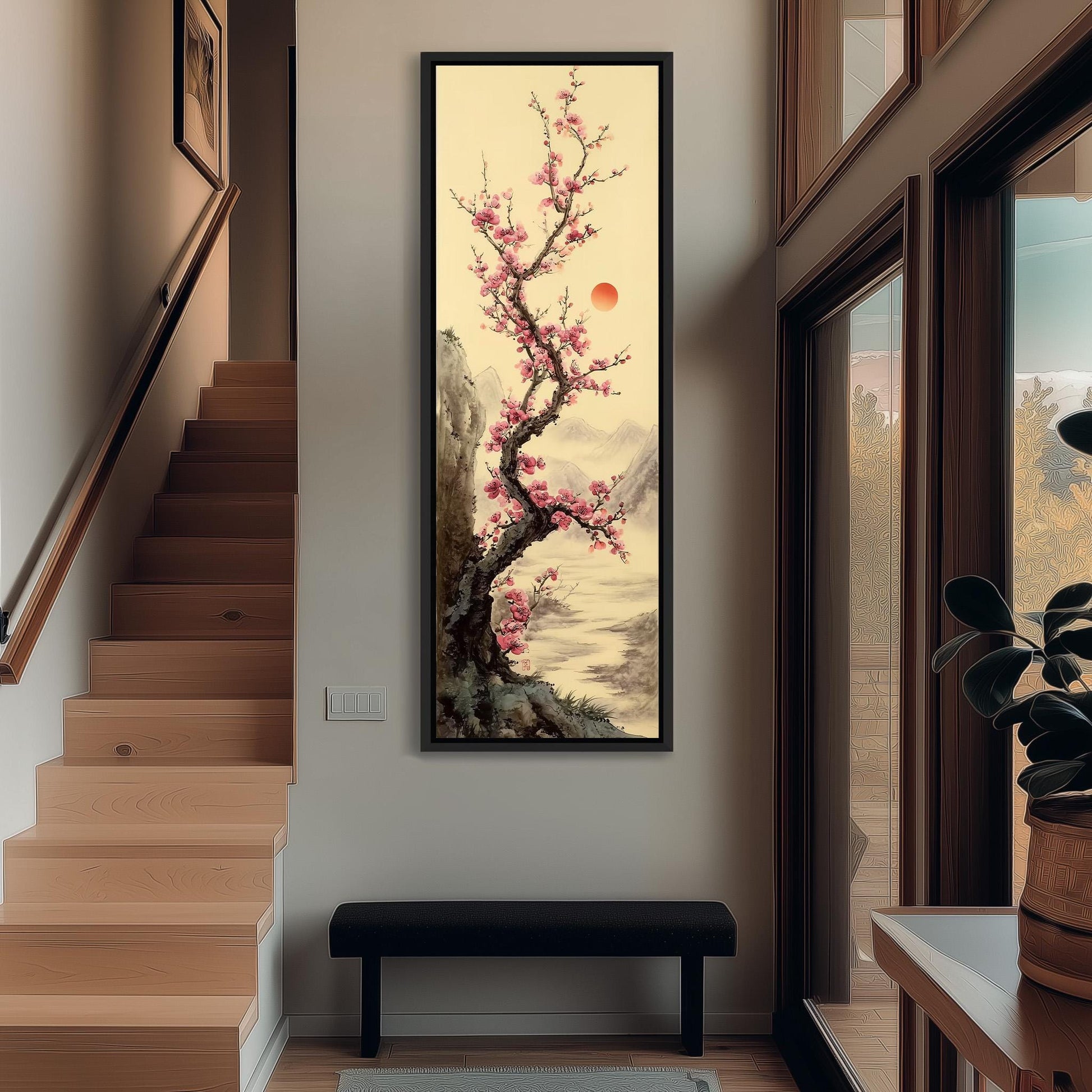 a large, framed painting of a cherry blossom tree with pink flowers hanging on the wall of a hallway. The painting is positioned above a bench, creating a focal point in the space.