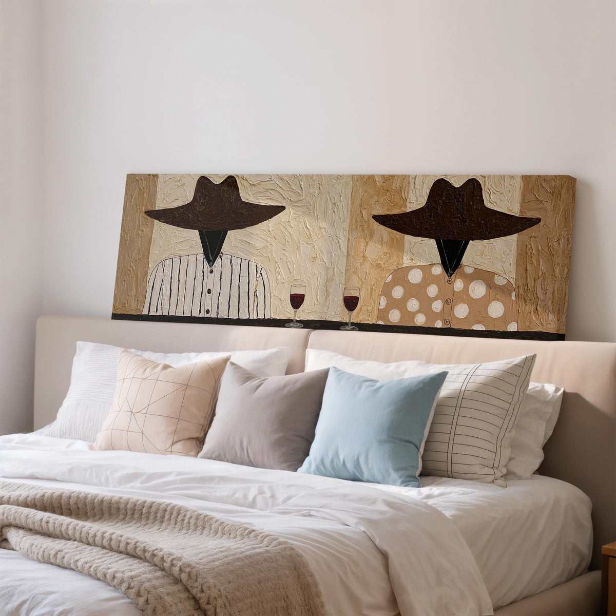 Two folk figures in hats toasting with red wine wide panoramic canvas print above a bed in a bedroom
