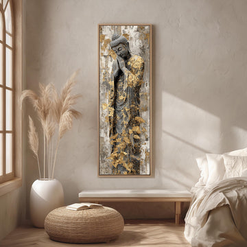 a large Buddha statue with golden leafy patterns on its robe, displayed on a wall in a minimalist living room setting.