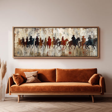 a large, framed painting of a group of people riding horses on a wall above a brown sofa in a living room setting.