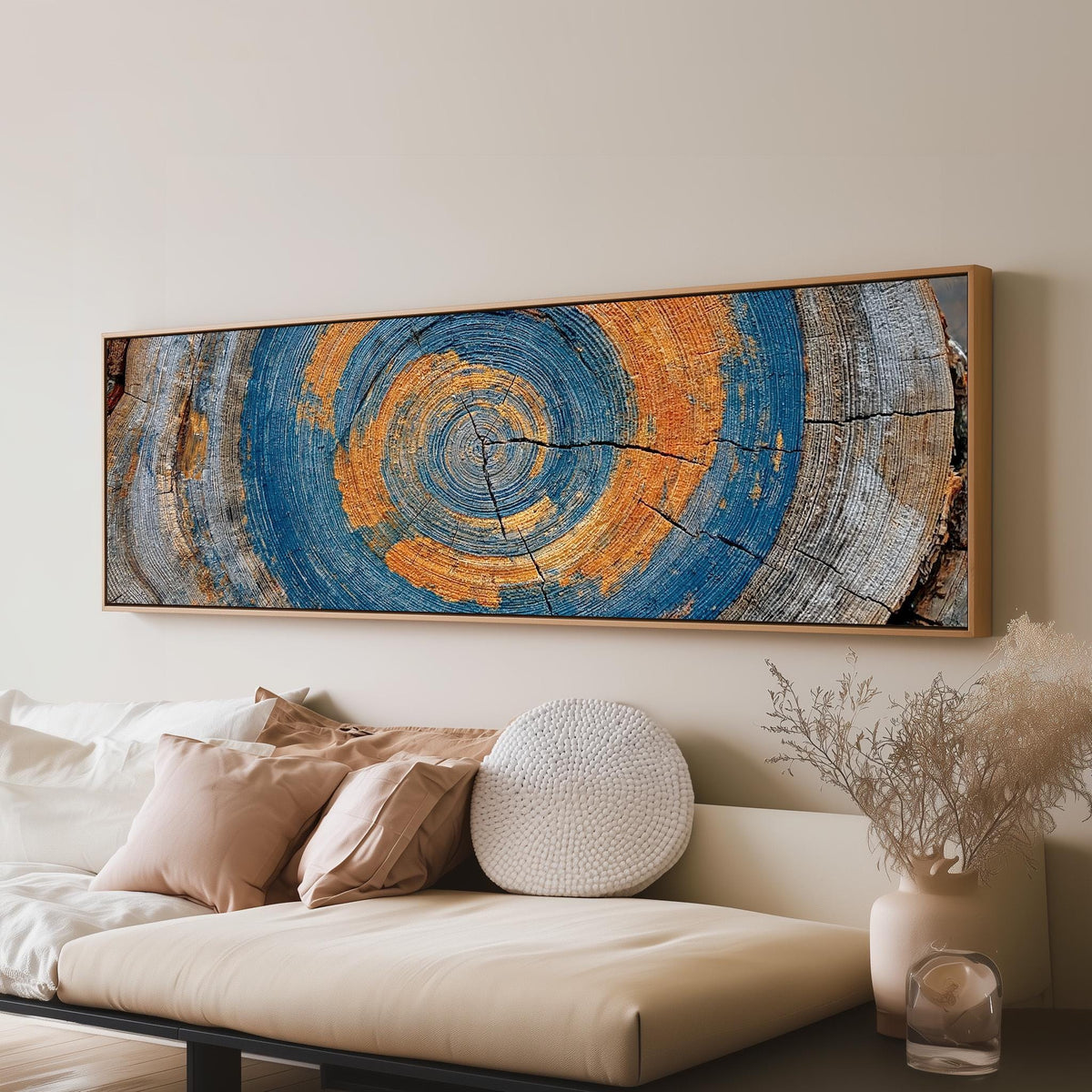 Blue and orange tree ring panoramic canvas print above a sofa in a living room