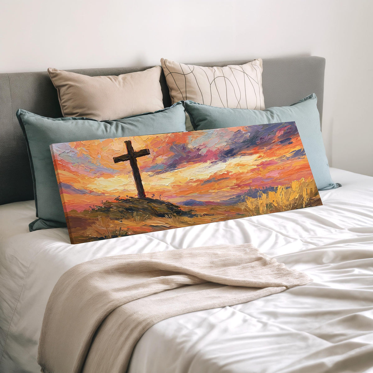 Cross on a hill at sunset wide panoramic canvas print laid on a bed to show its size