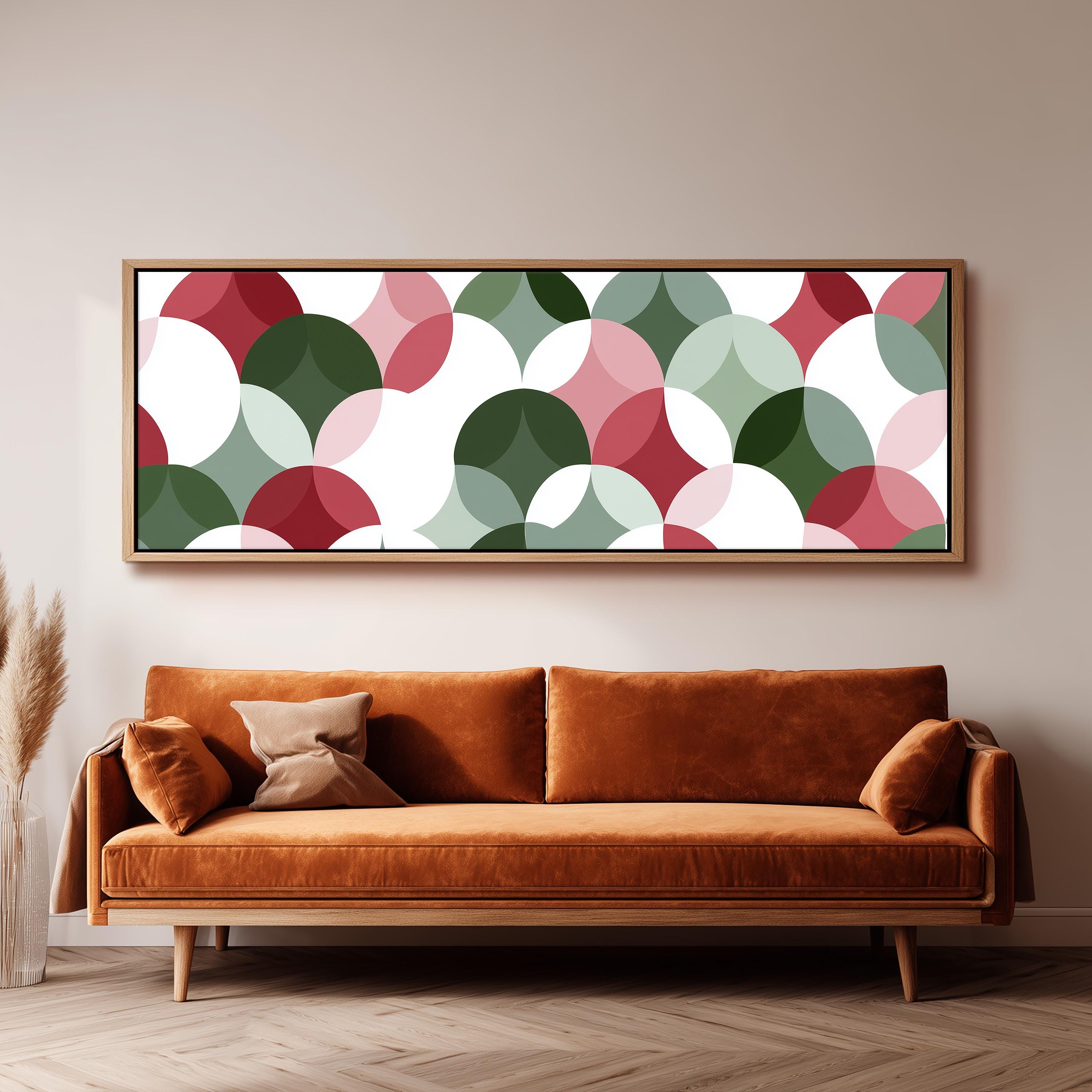 a large, rectangular, abstract art piece hanging on a wall above a brown sofa with two pillows.