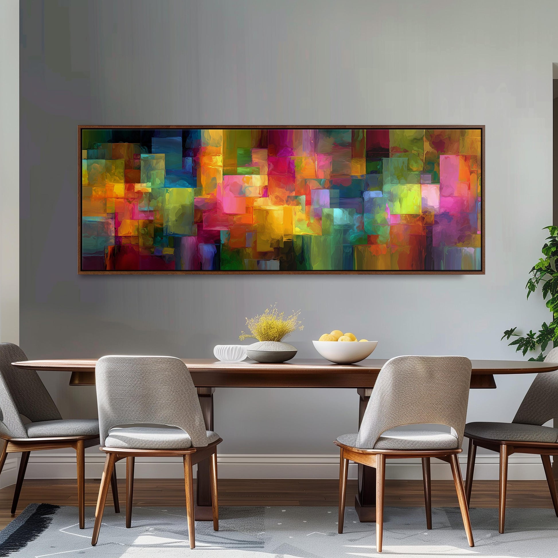 a modern dining room with a large, colorful abstract painting hanging on the wall above a wooden dining table. The table is set with a bowl of fruit and a vase of flowers, creating a welcoming and vibrant atmosphere. The room is furnished with four chairs, two on each side of the table, and a potted plant is placed on the right side of the room.