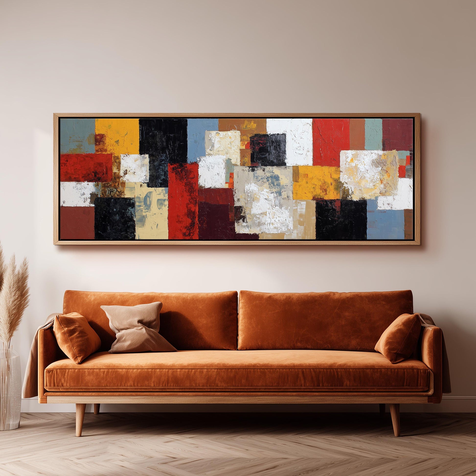 a large, abstract painting hanging on a wall above a brown sofa in a living room setting.