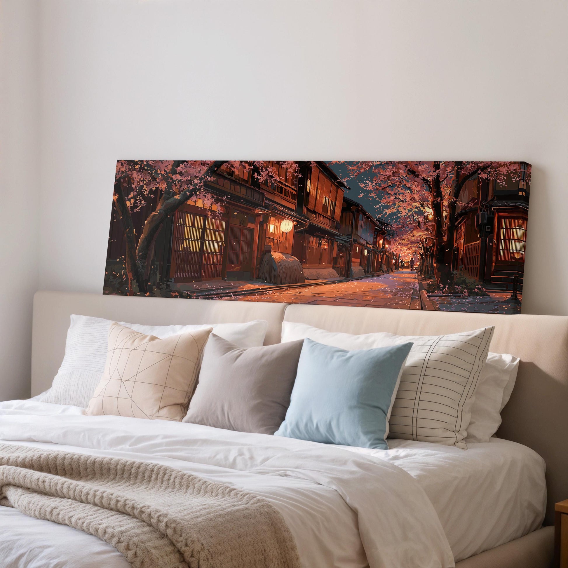 a large, colorful painting of a street scene with cherry blossoms hanging above a bed with white linens and pillows.
