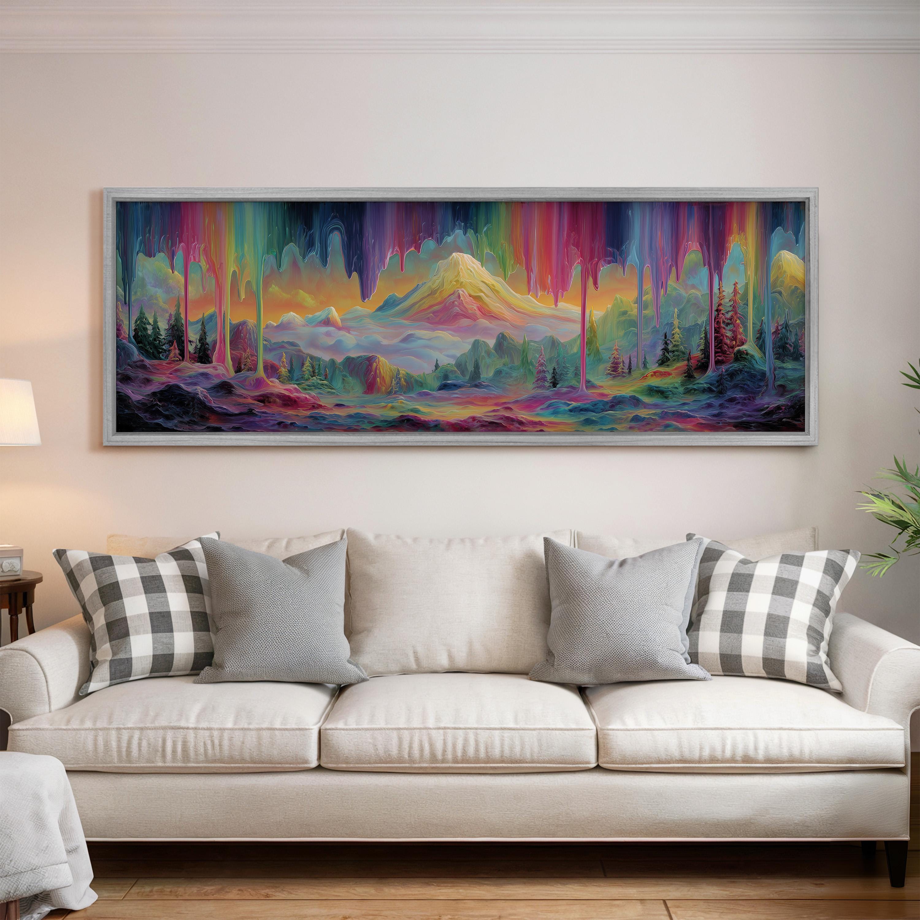 a large, colorful painting of a mountainous landscape hanging on a wall above a white couch with gray and white plaid throw pillows.