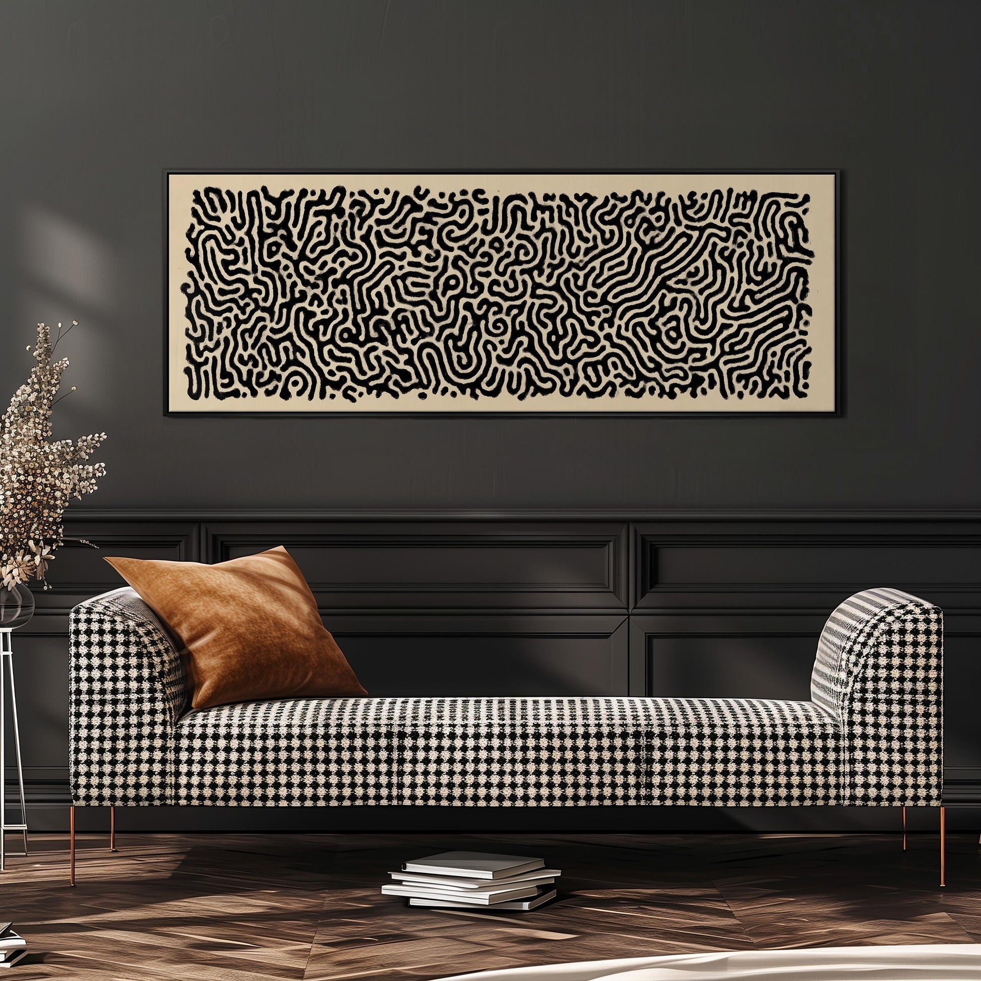 a black and white checkered sofa with a brown throw pillow, set against a dark wall with a large abstract painting hanging above it.
