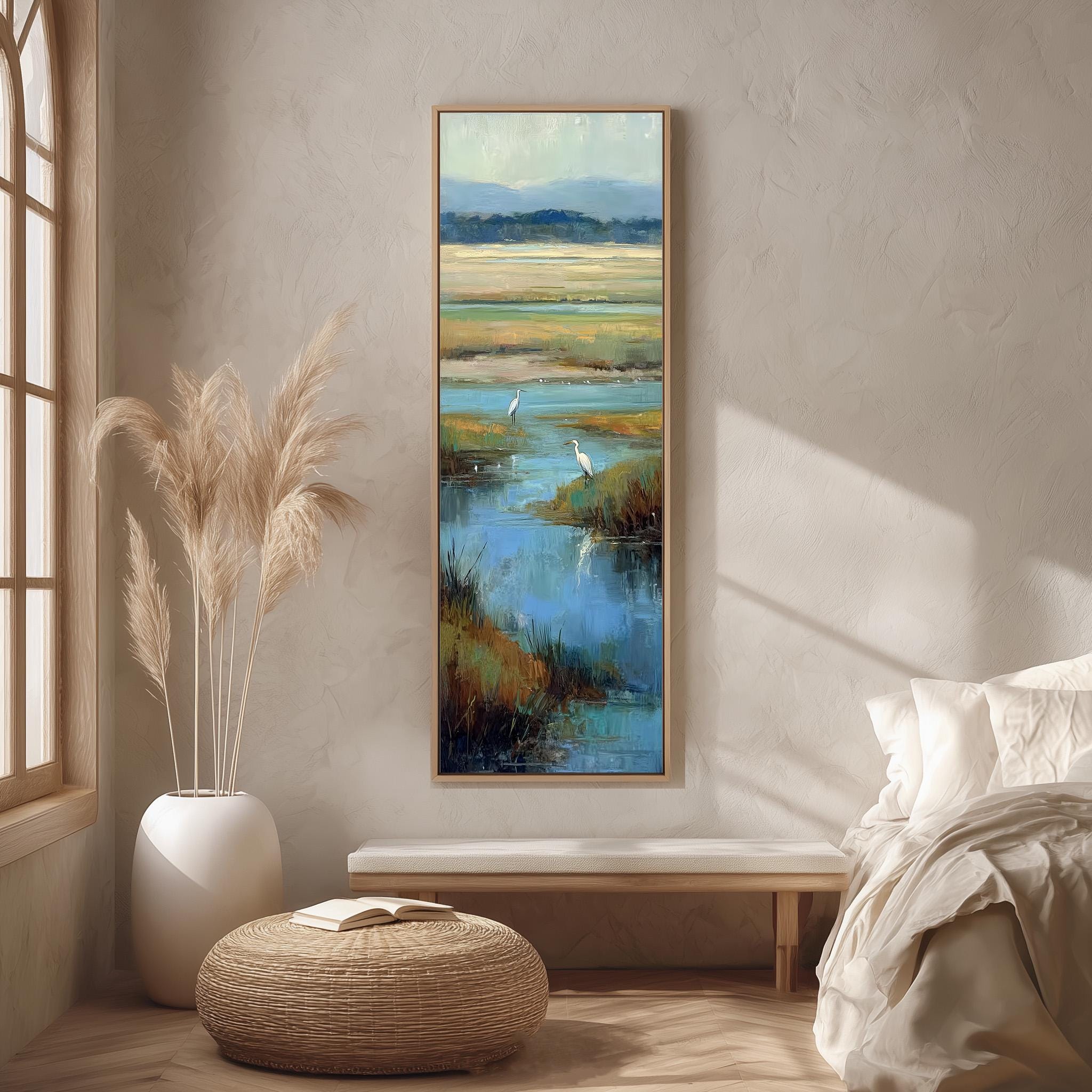 a serene bedroom scene with a large painting of a tranquil body of water and a bird in the foreground, a white bed with a white pillow, and a wicker ottoman.