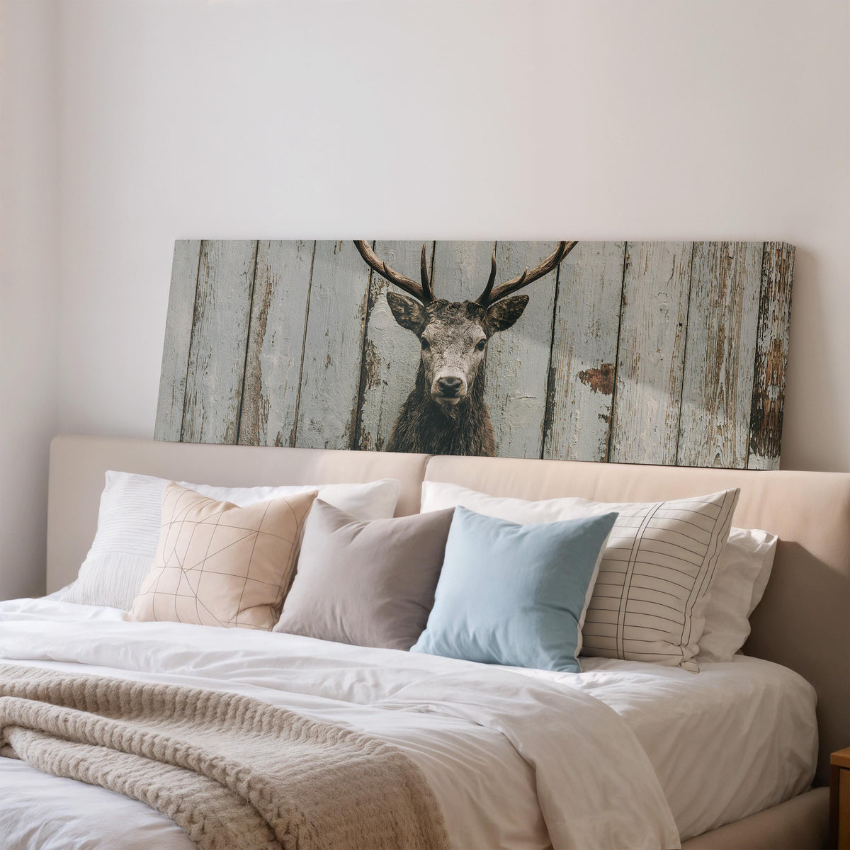 Monochrome stag on barn wood wide panoramic canvas print above a bed in a bedroom