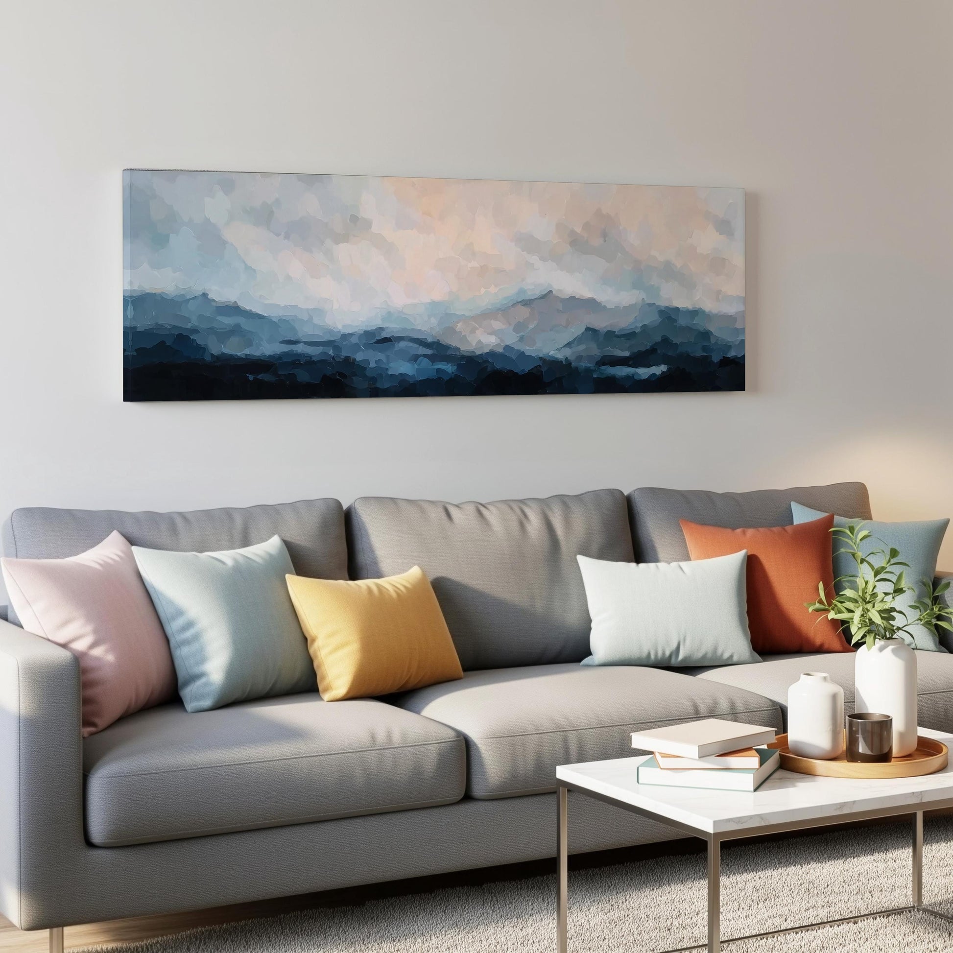 a gray couch with colorful throw pillows, a white coffee table, and a large abstract painting hanging on the wall above the couch.