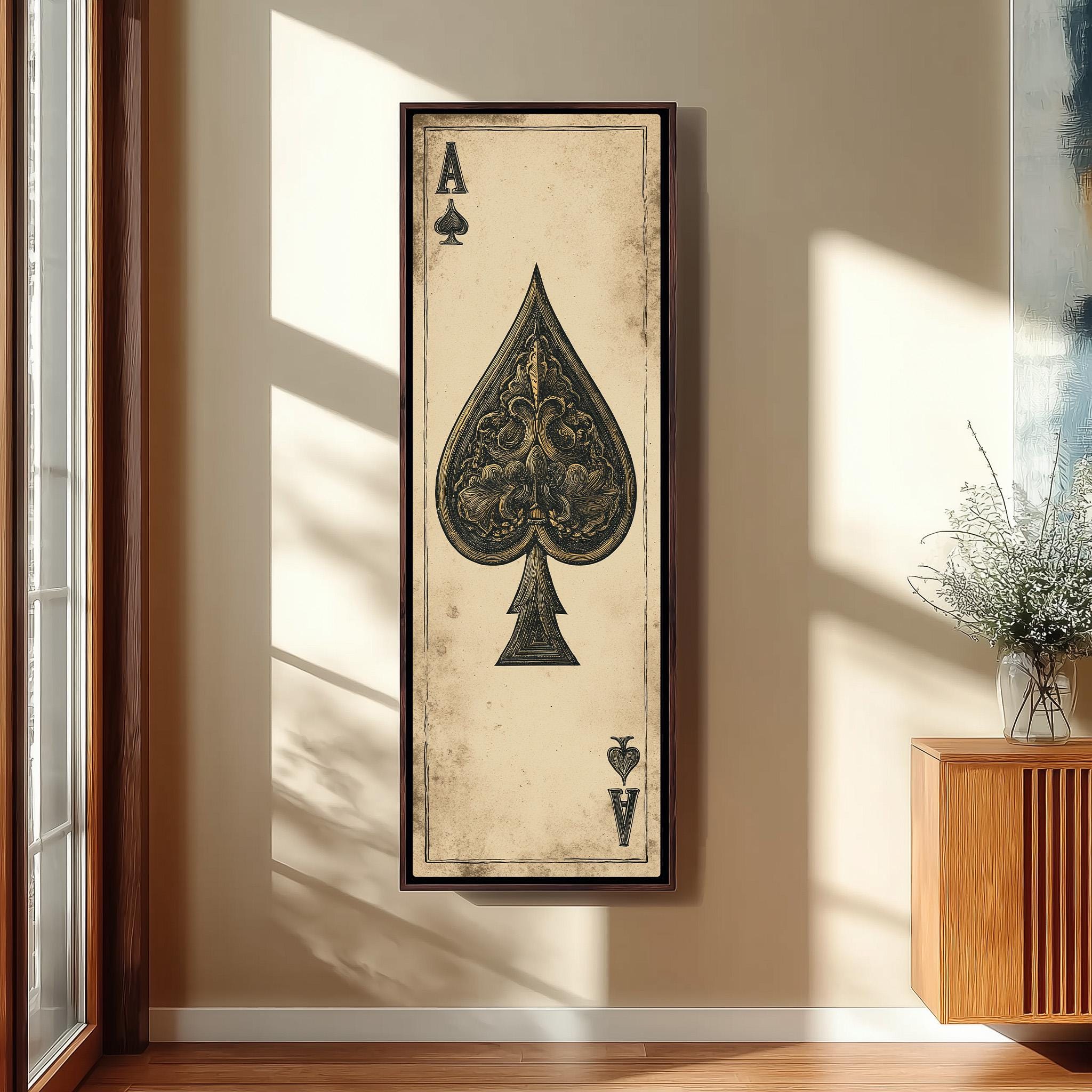 a framed artwork of a spade playing card, which is hanging on a wall.