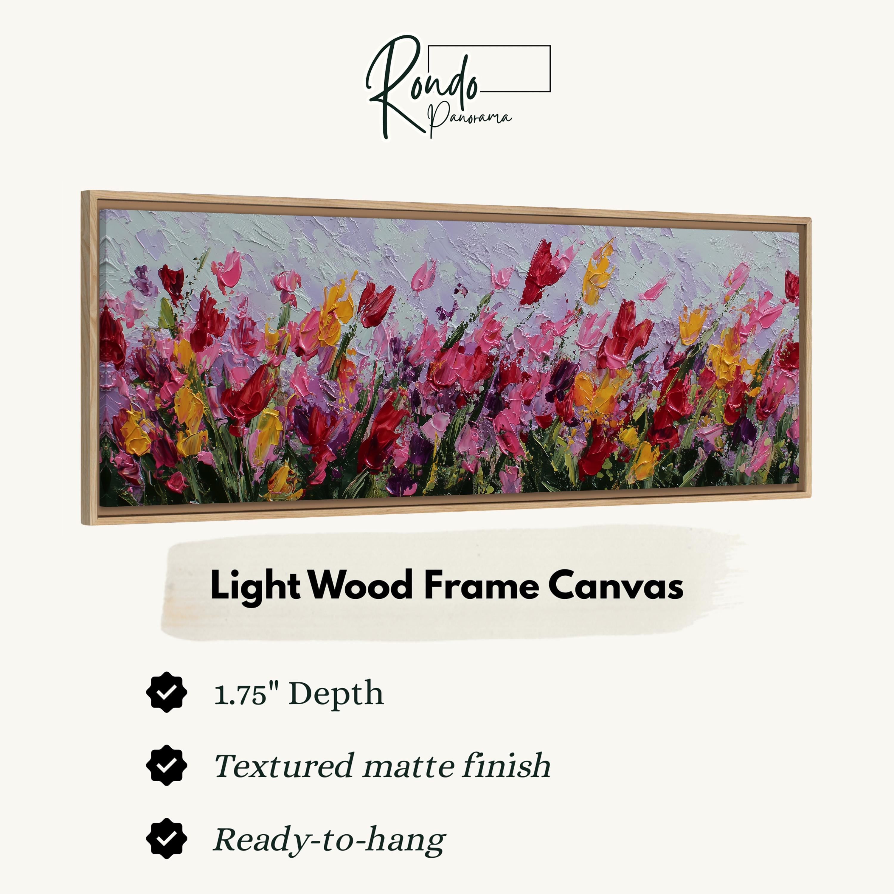 The image is a framed artwork depicting a field of colorful flowers, with a light wood frame.