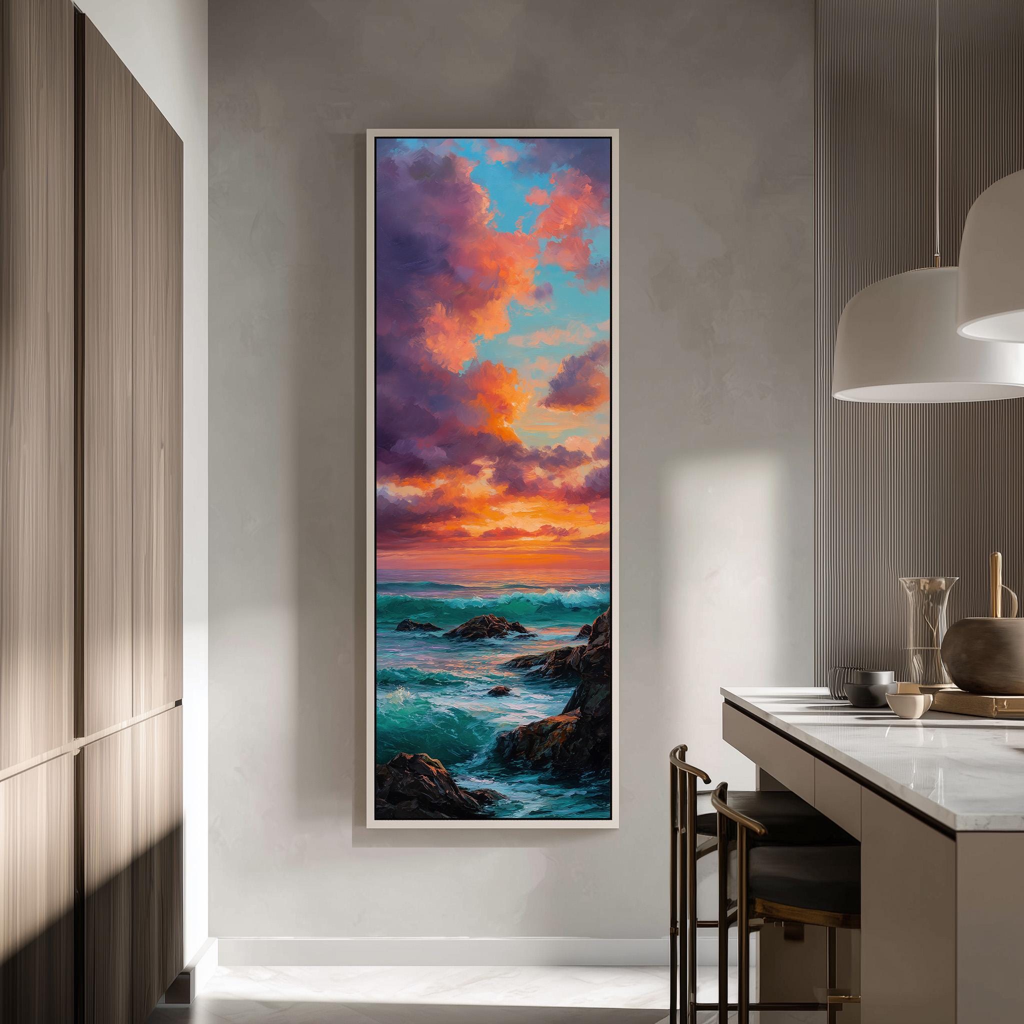 a large, framed painting of a seascape with a vibrant sunset over the ocean. The painting is hanging on a wall in a modern kitchen, with a countertop and chairs visible in the background.