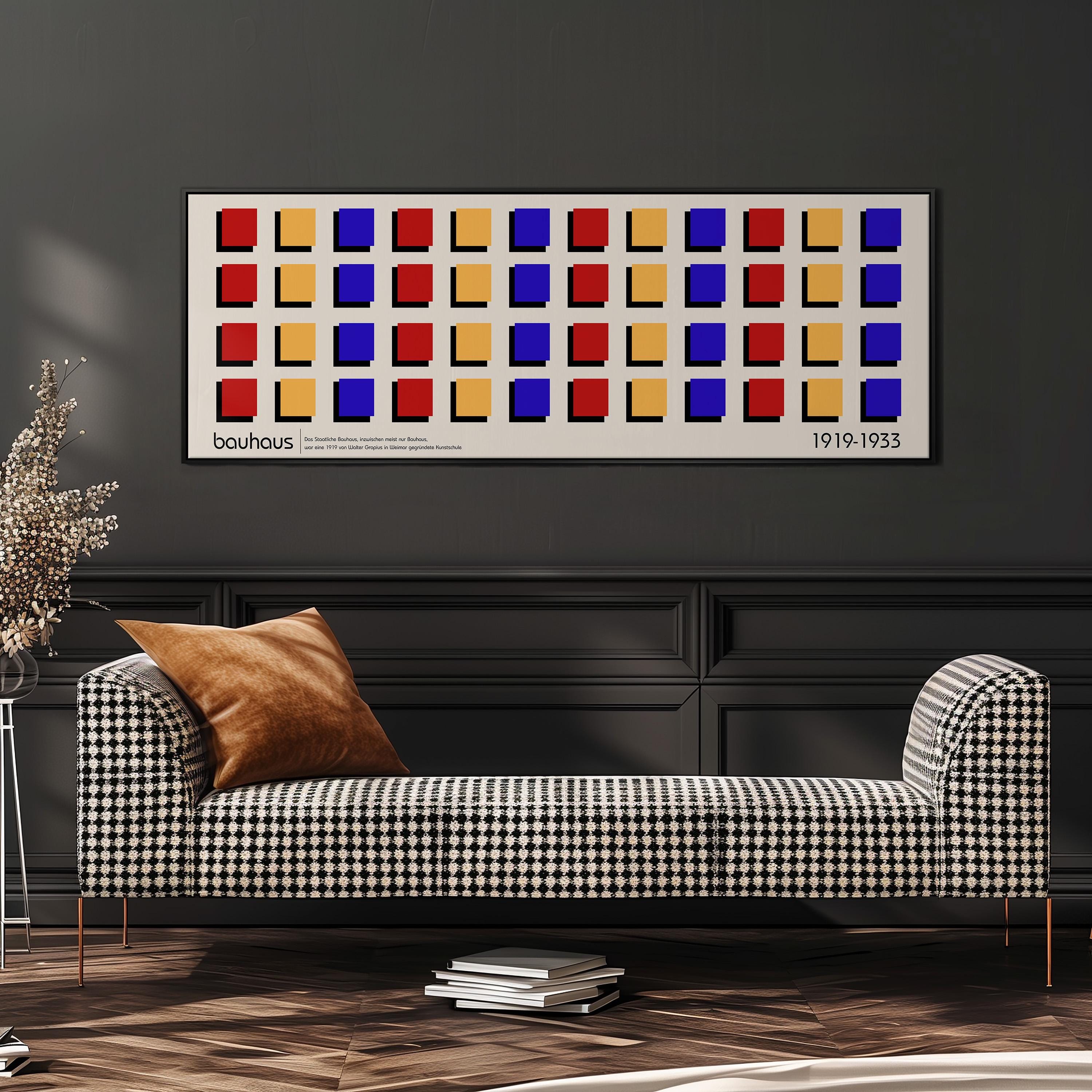 a modern living room with a checkered sofa, a stack of books, and a potted plant. Above the sofa, there is a framed artwork with a geometric pattern of squares in various colors.