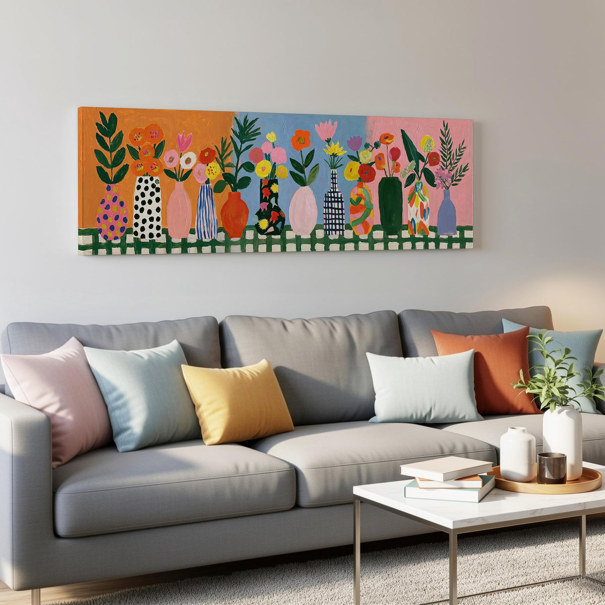Folk art flower vases on orange and blue panoramic canvas print above a grey sofa in a living room