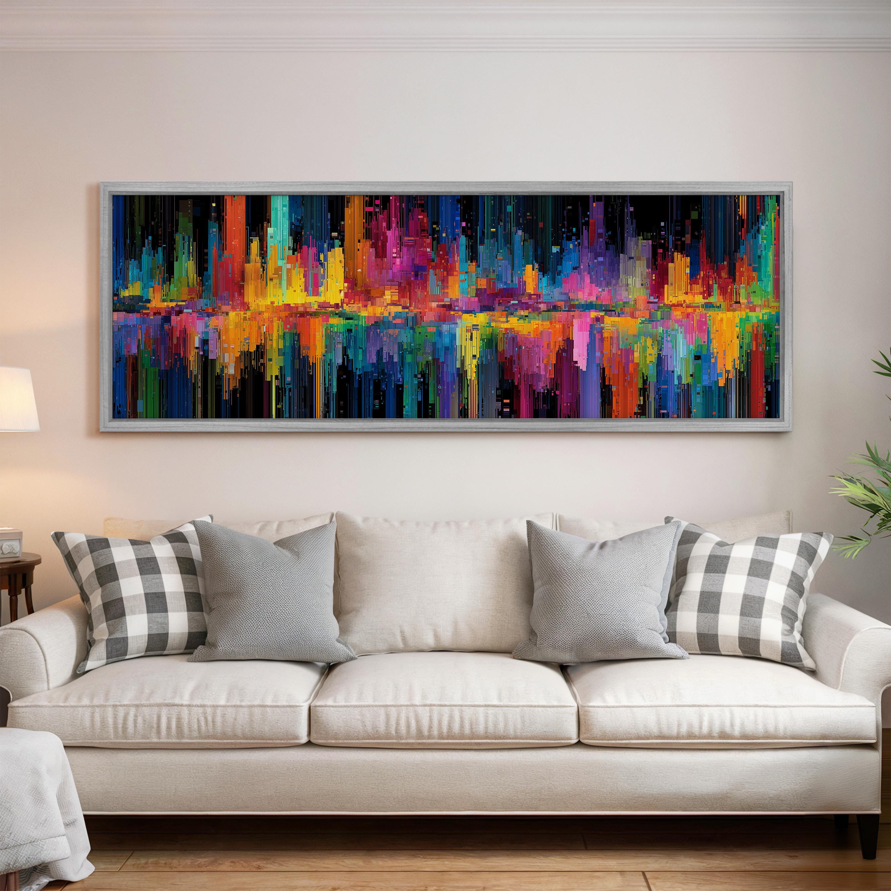 a large, colorful abstract painting hanging on a wall above a white couch in a living room.