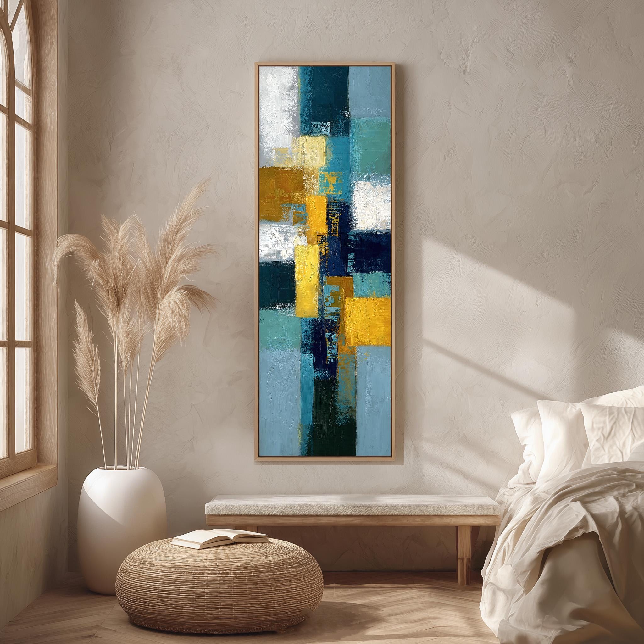 a modern living room with a large abstract painting hanging on the wall, a white sofa, a wicker ottoman, and a potted plant.