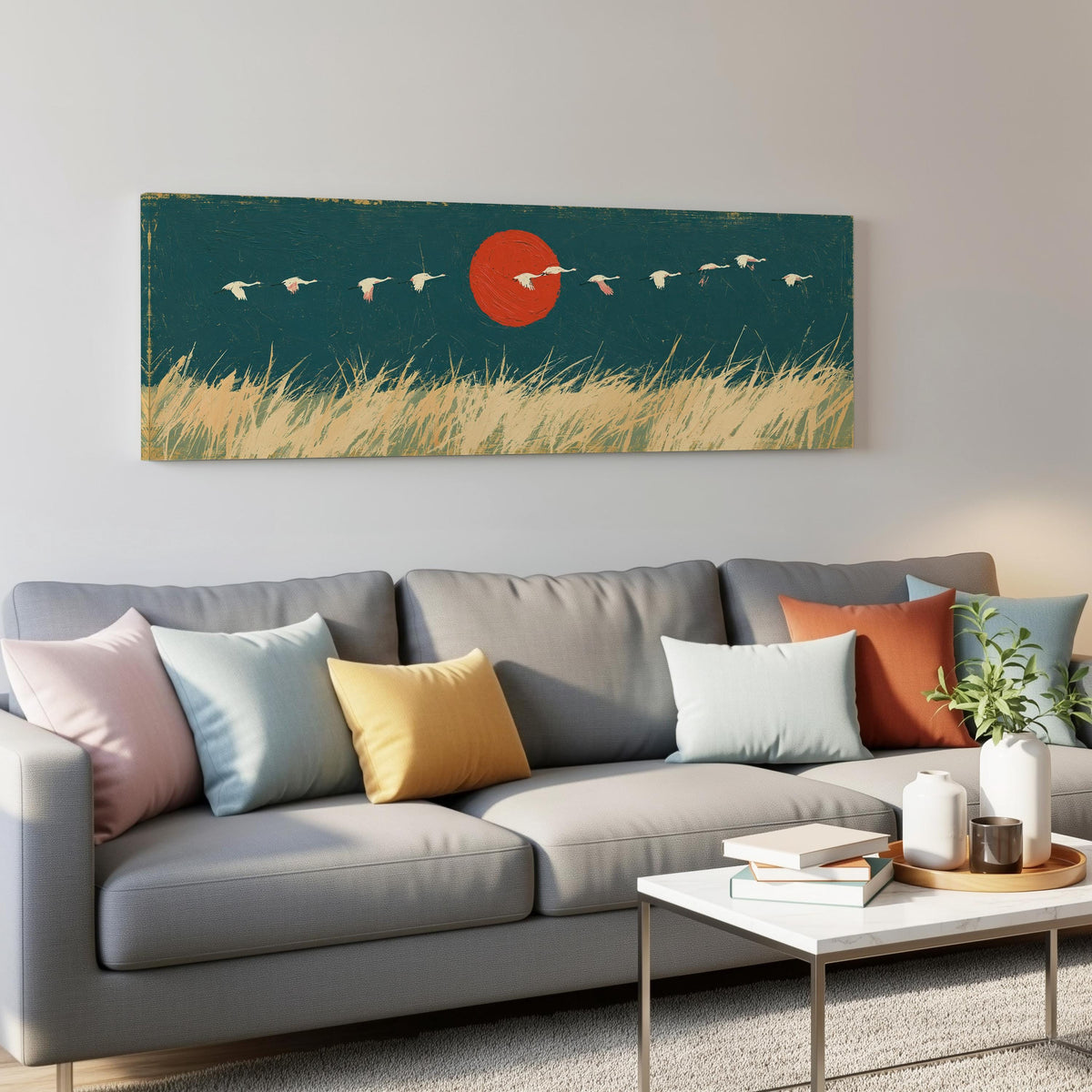 Bird flock over a prairie under a red sun panoramic canvas print above a grey sofa in a living room