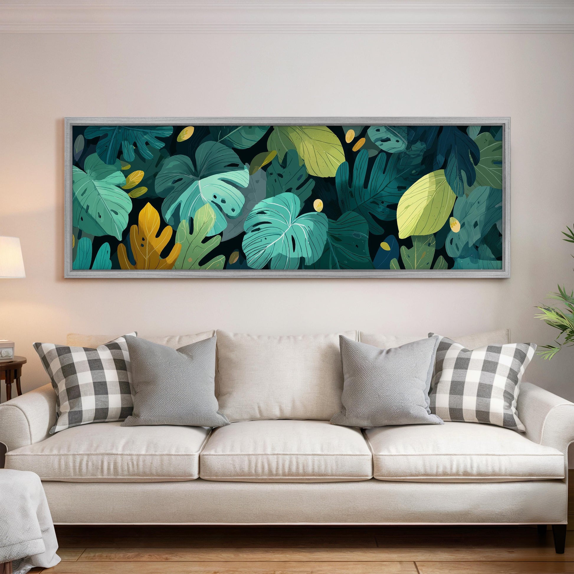 a large, colorful painting of tropical leaves hanging on a wall above a white couch in a living room.
