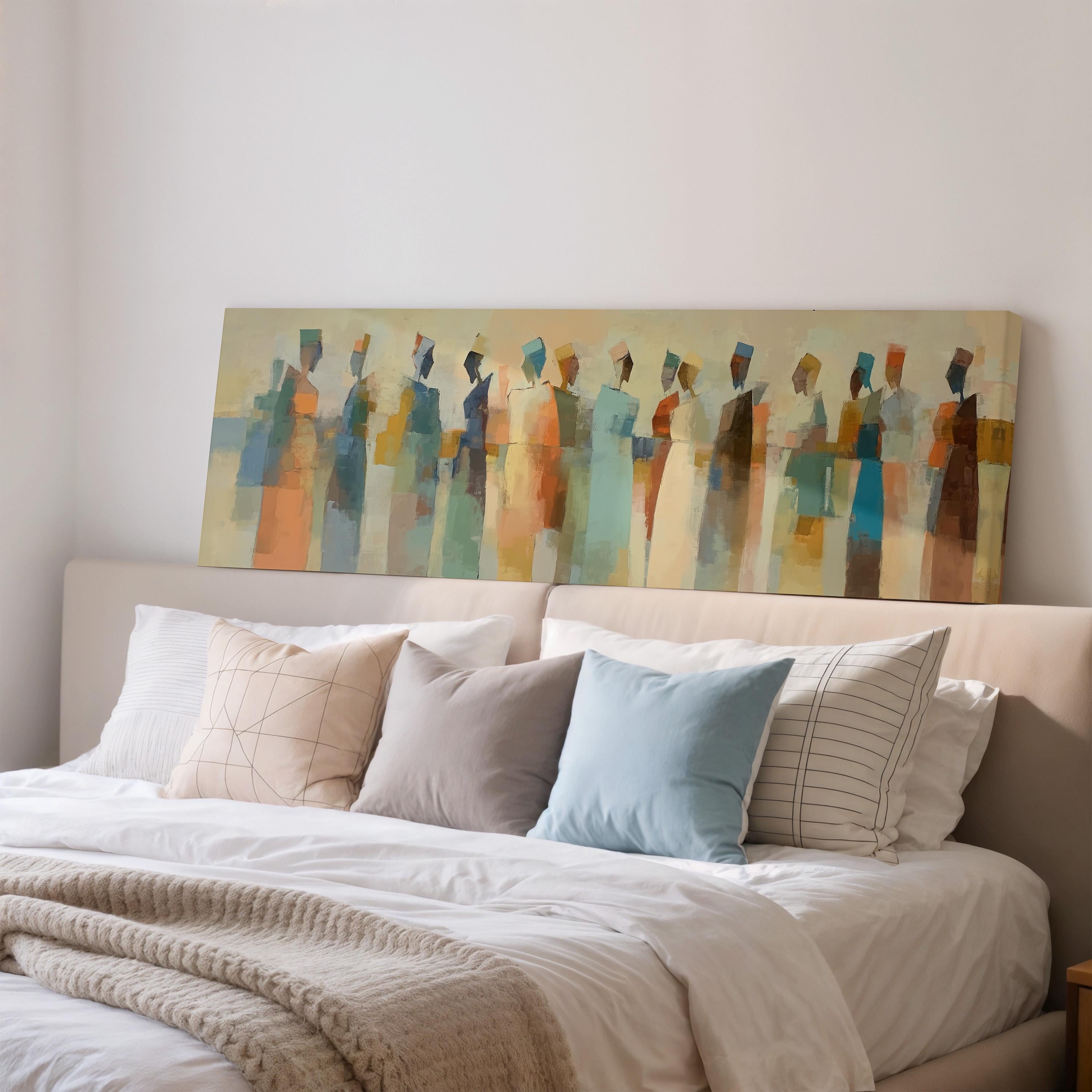 a large abstract painting hanging above a bed with white pillows and a gray blanket.