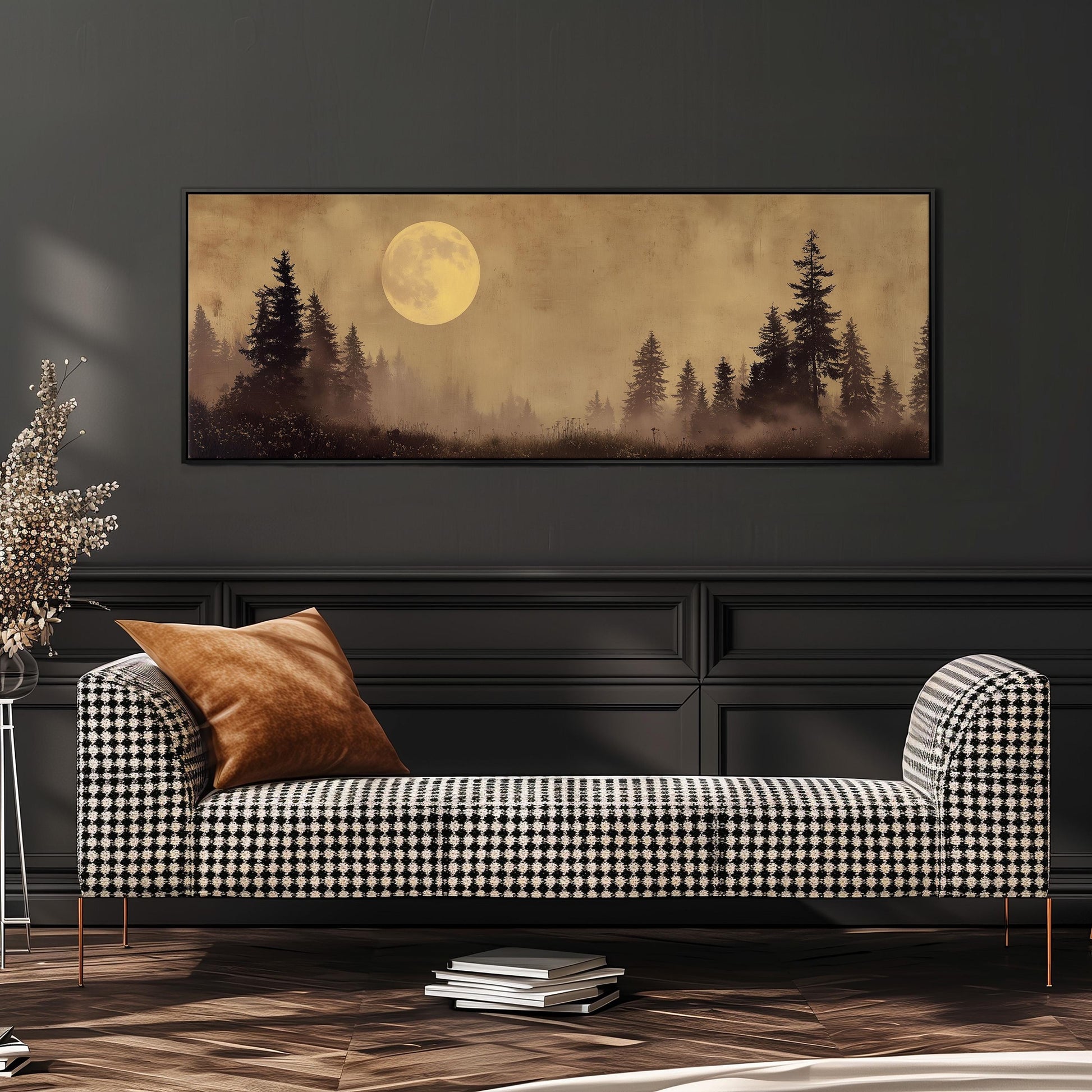 a large, framed painting of a forest scene with a full moon in the background, hanging on a wall above a black and white checkered sofa.