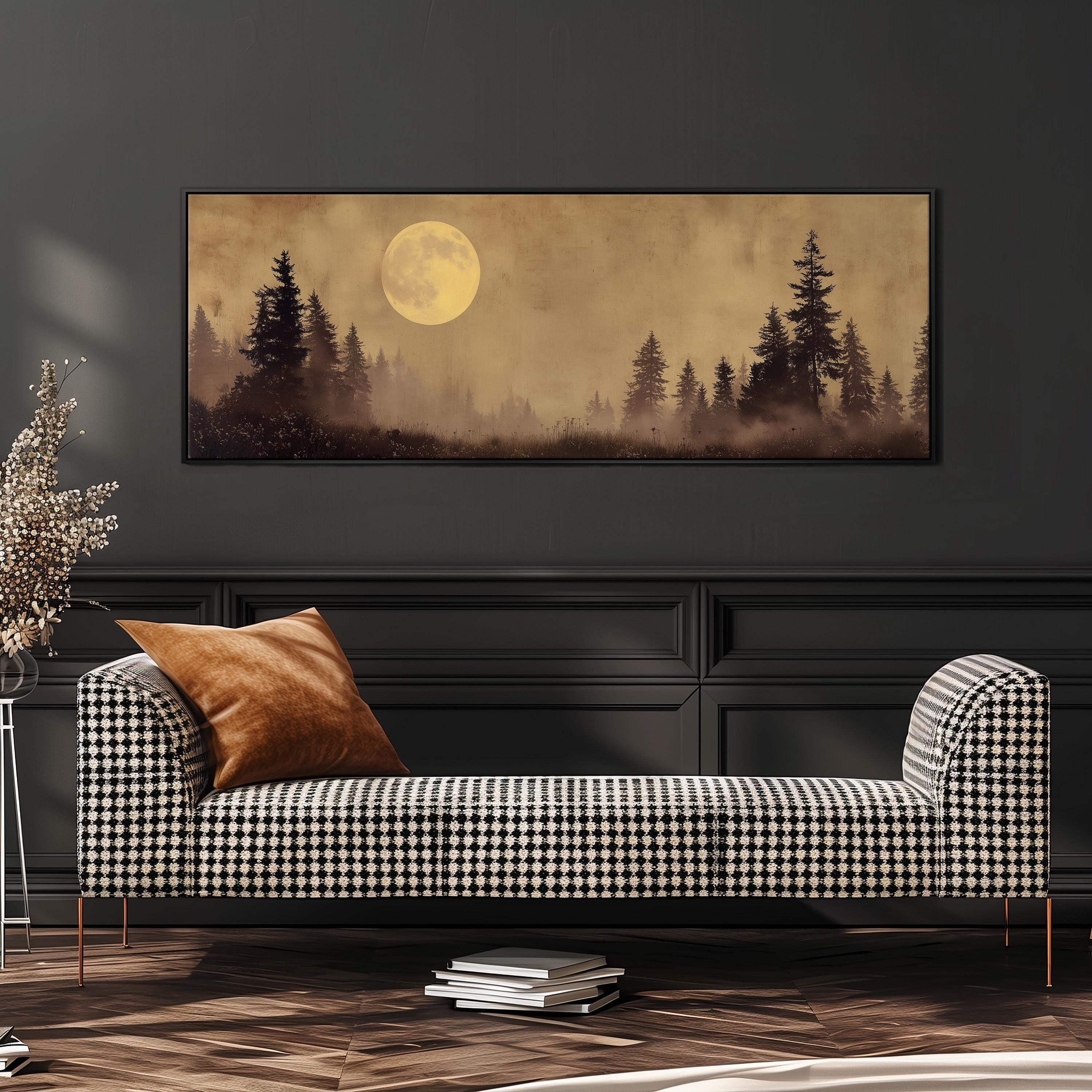 a large, framed painting of a forest scene with a full moon in the background, hanging on a wall above a black and white checkered sofa.