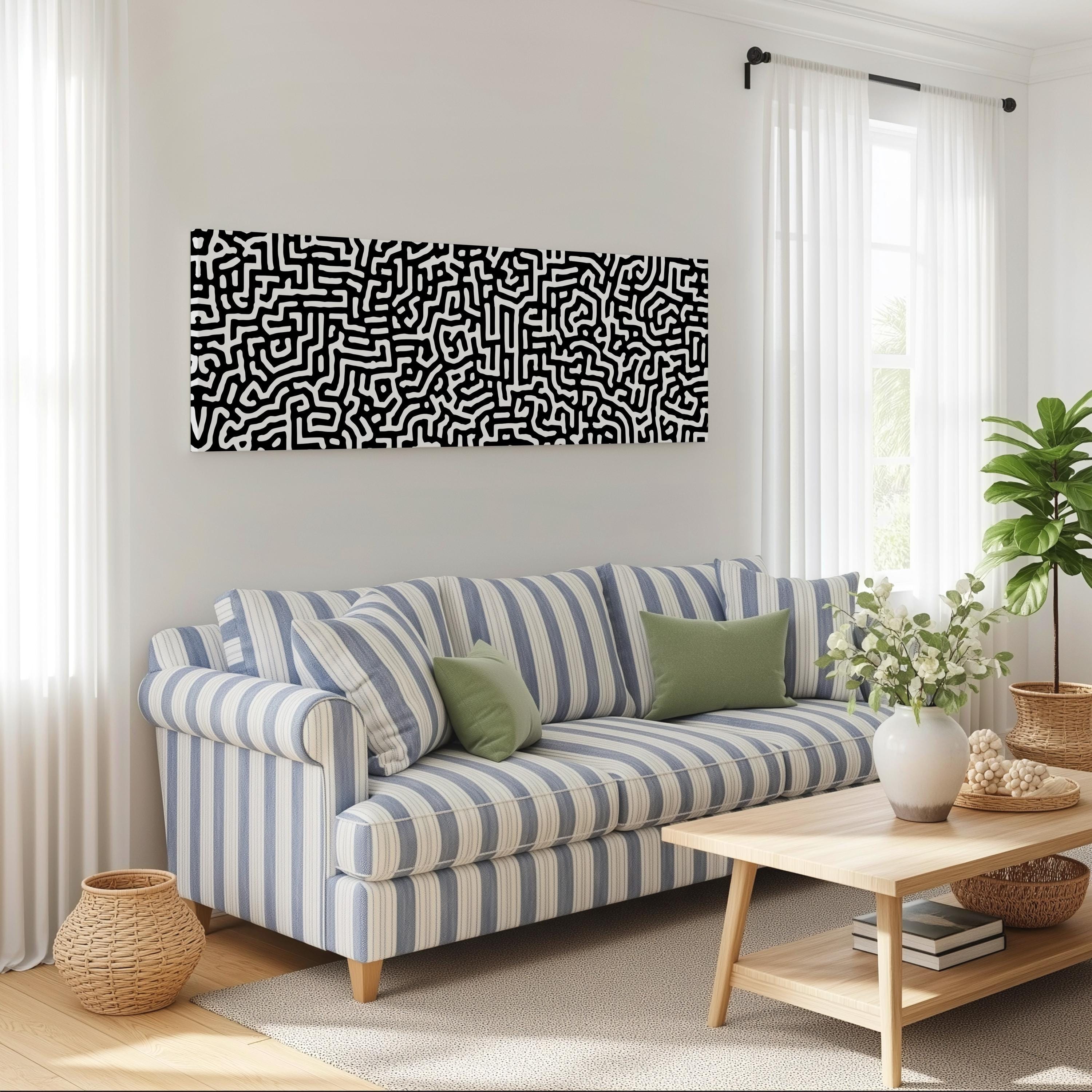 a living room with a striped blue and white sofa, a wooden coffee table, and a large abstract painting on the wall above the sofa.