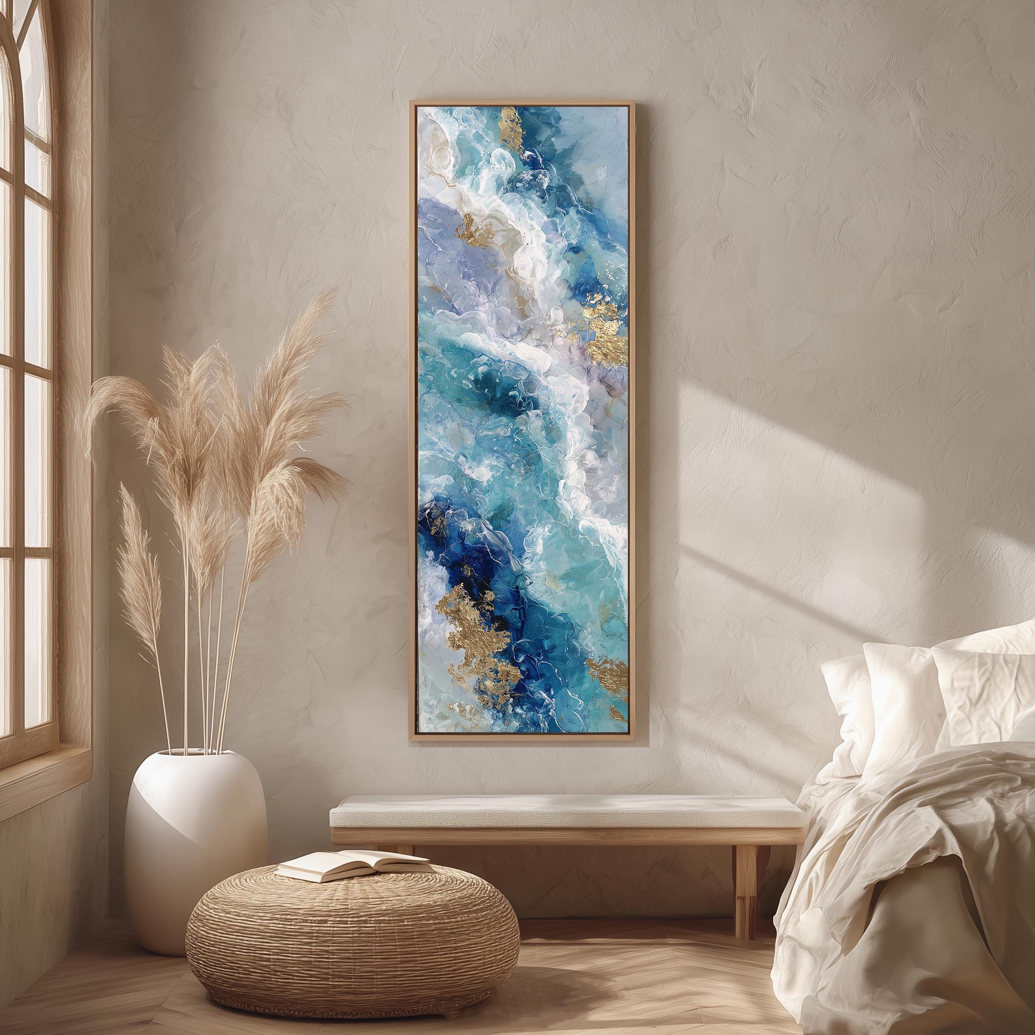 a large abstract painting hanging on a wall in a bedroom setting. The painting has a blue and white color scheme with gold accents, creating a striking contrast. The room is decorated with a white bed, a wicker ottoman, and a potted plant, contributing to a serene and elegant atmosphere.