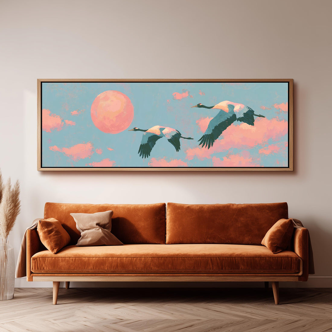 Two cranes flying at sunset long horizontal canvas print above a sofa in a living room